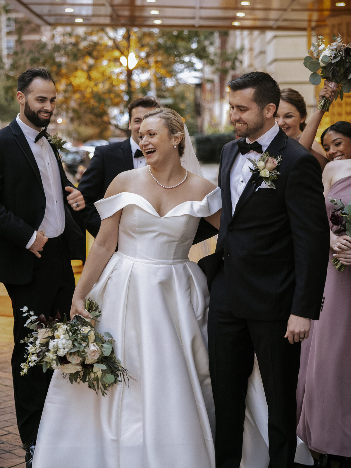 candid-emotional-moment-between-newlyweds-and-wedding-party