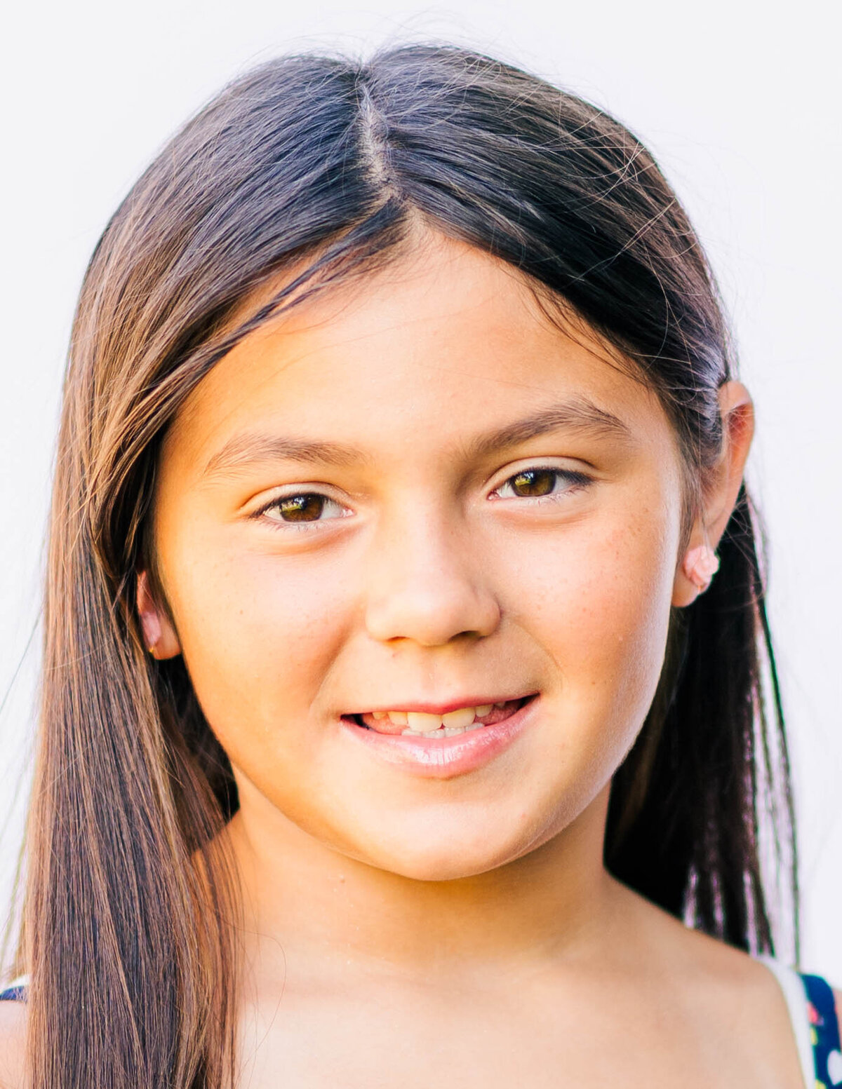 School portrait of girl in 5th grade, natural expression and soft tones