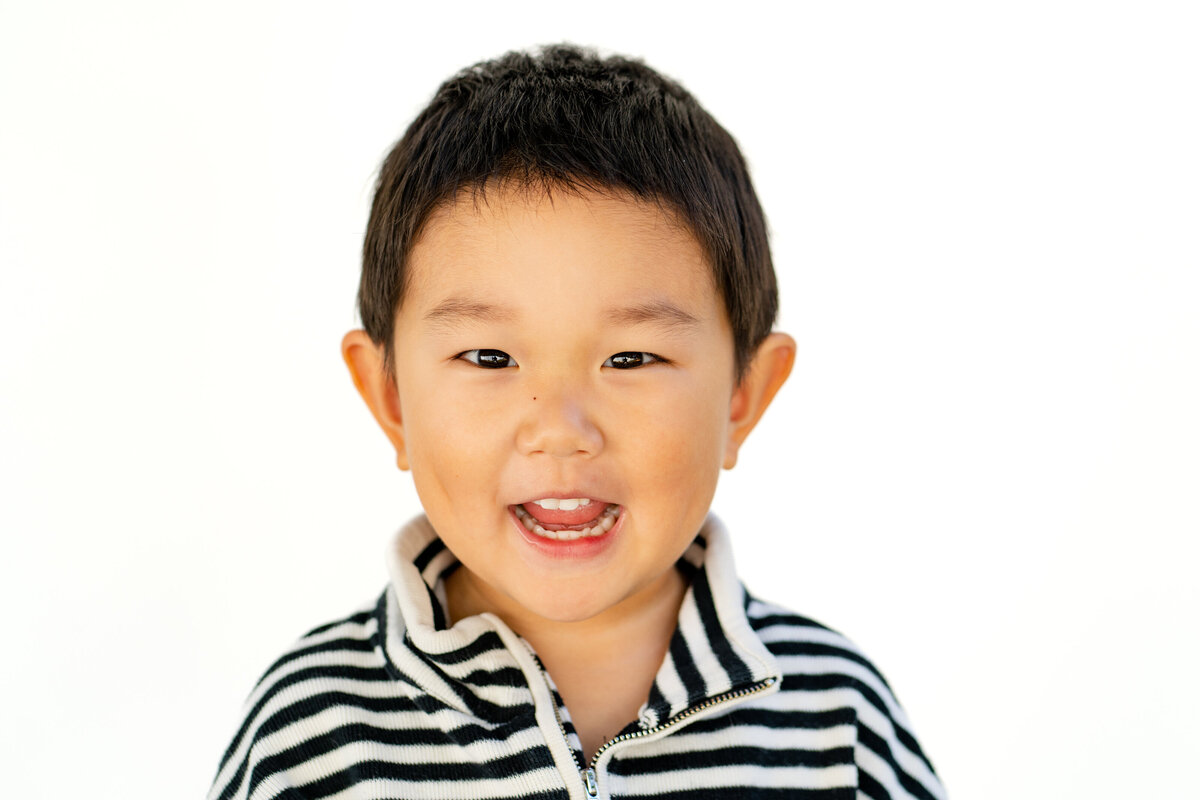 Little boy smiling for fine art school photo in Boston, MA