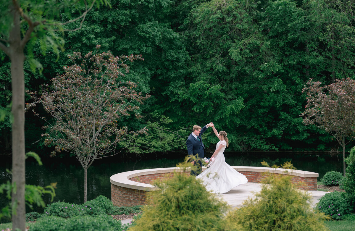 A groom twirls his bride at their wedding venue in Italy