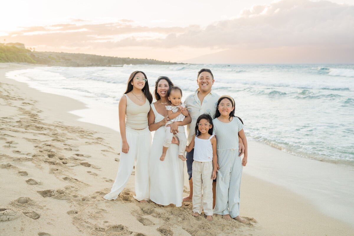 Photo by Maui family photographers Karma Hill Photography in West Maui Ironwood Beach with a pink sunset.