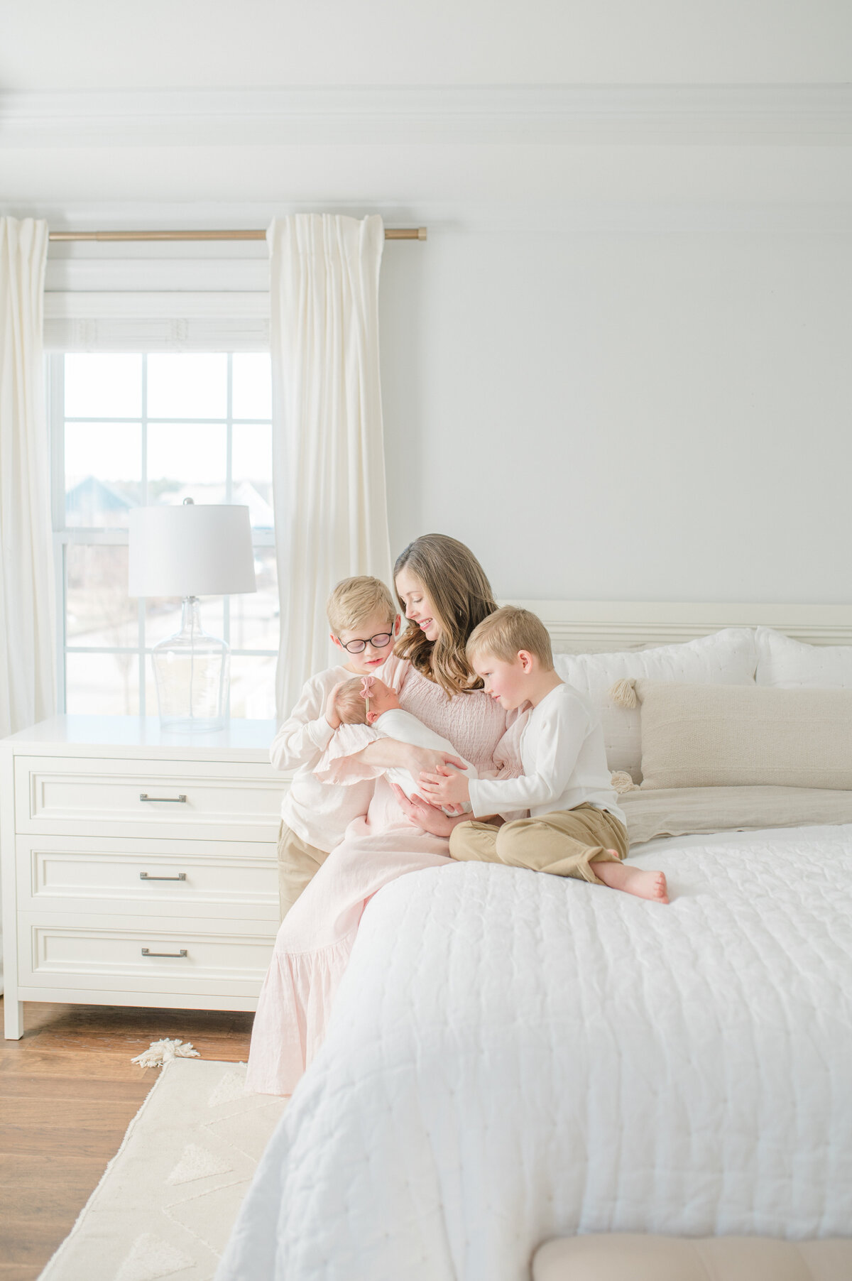 mom-and-brothers-snuggling-baby-sister