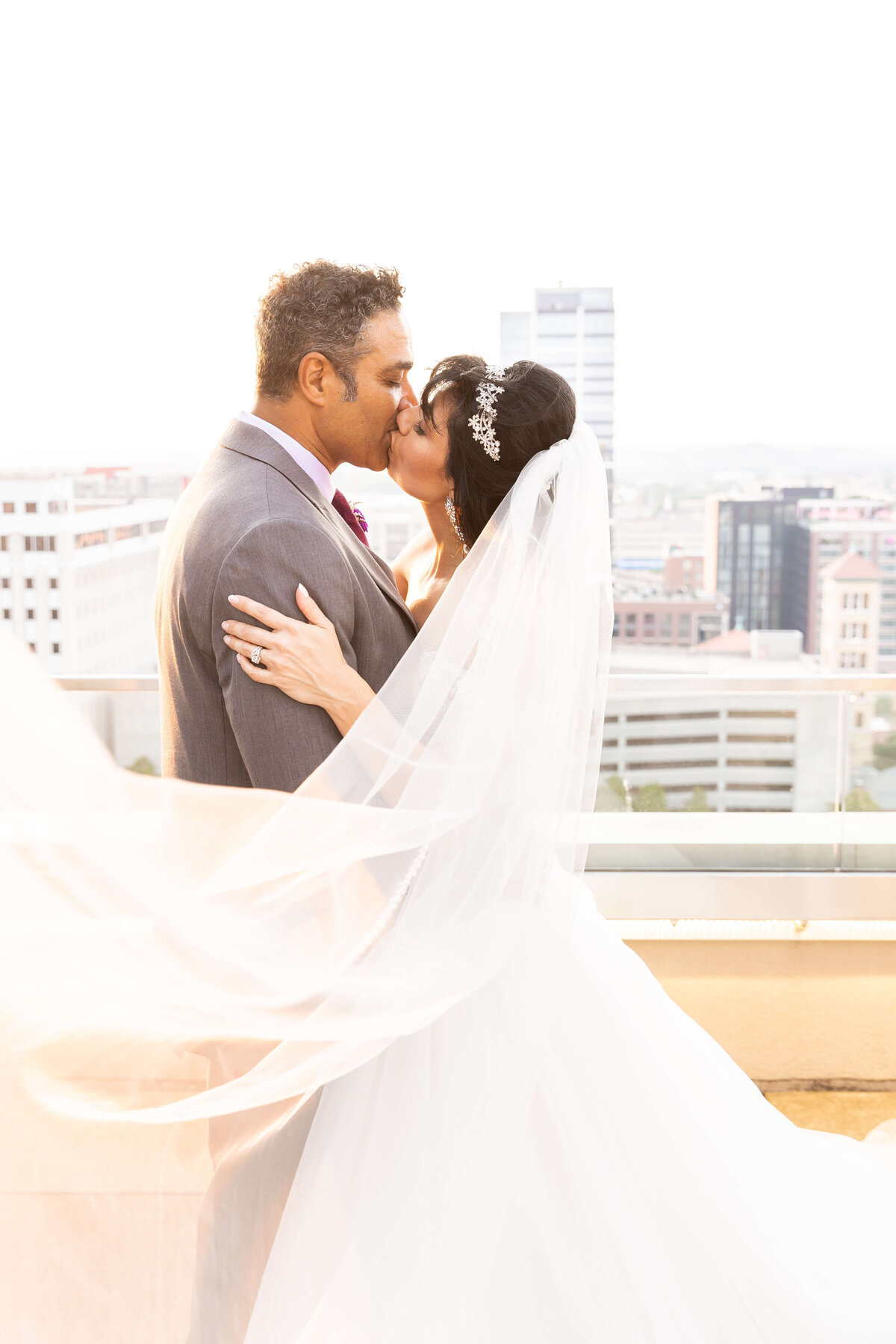 Bride and groom kissing on the rooftop at The Aertson hotel, Nashville