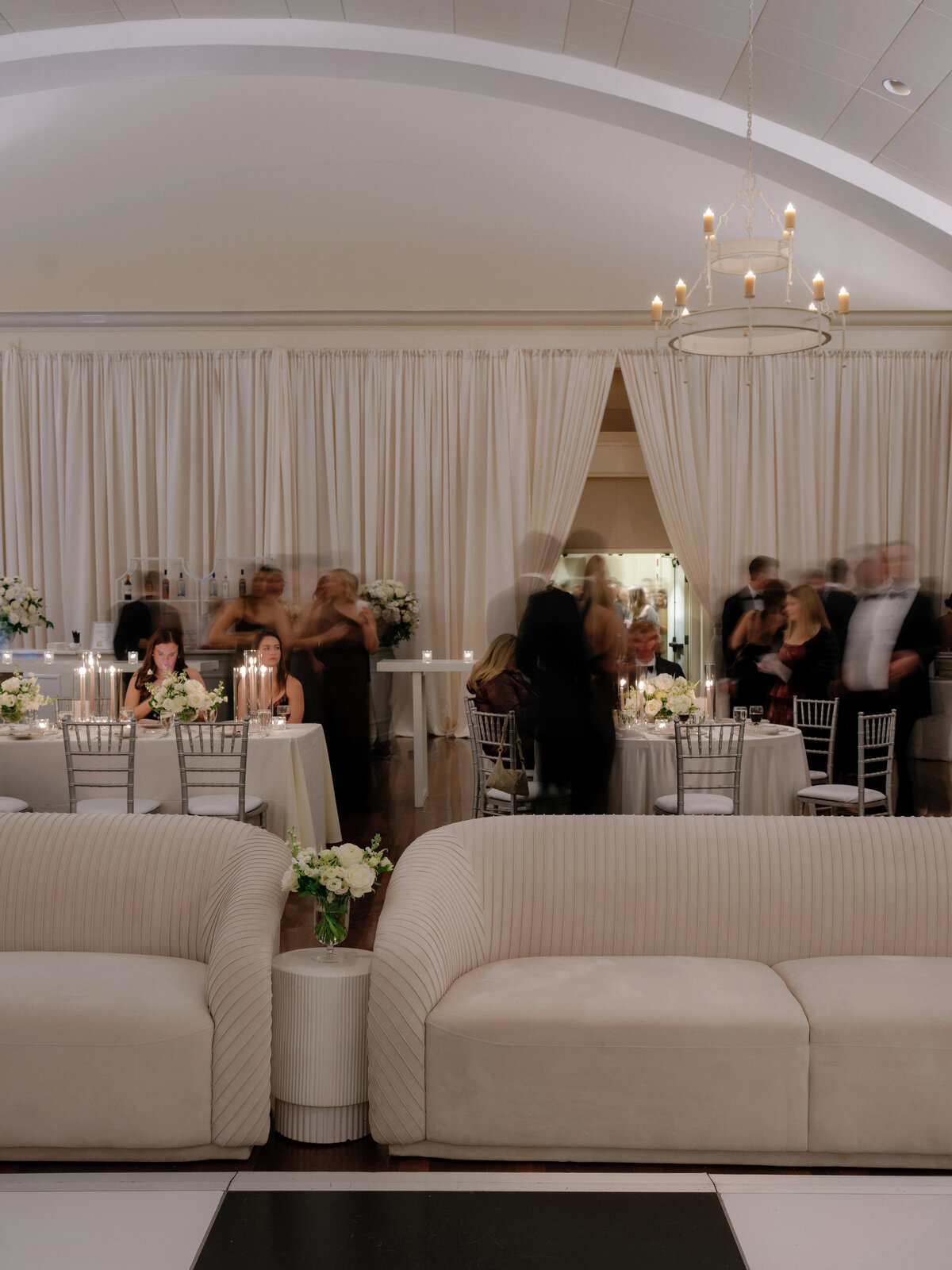 Wedding reception setup with lounge couches and beautiful drapery