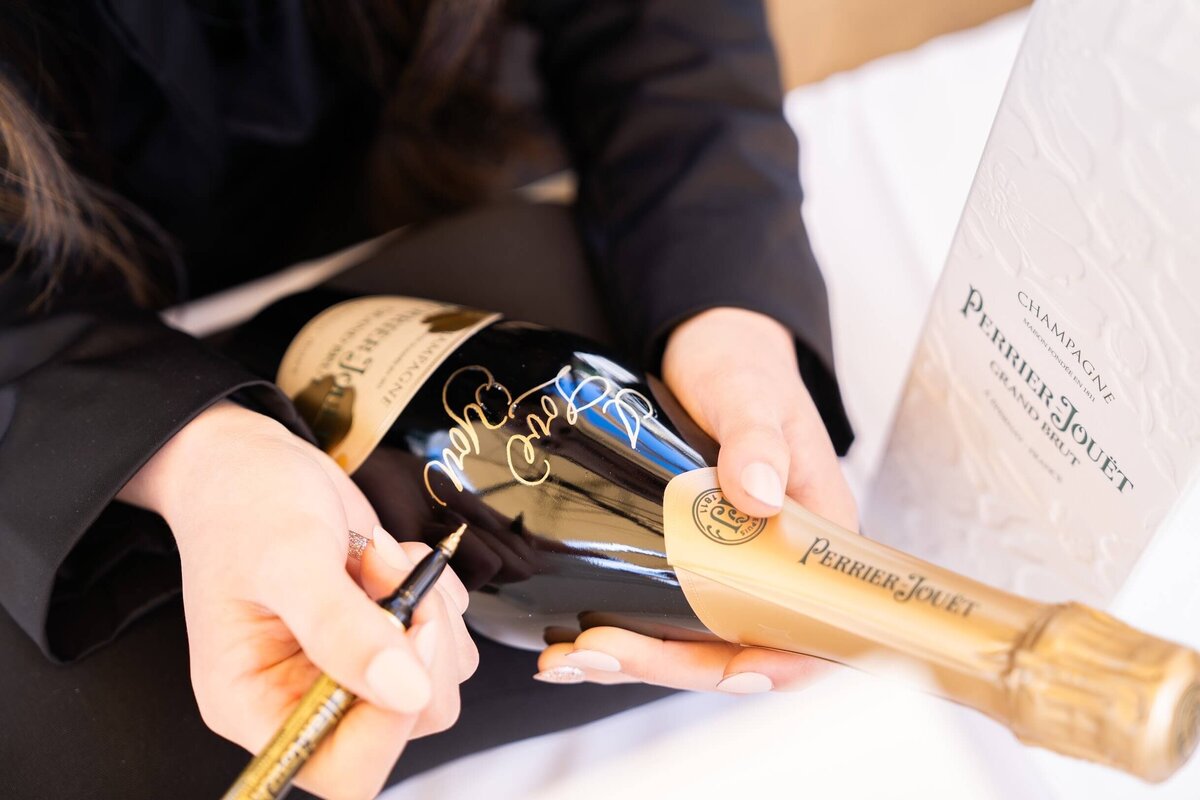 Custom handwritten calligraphy on champagne bottle