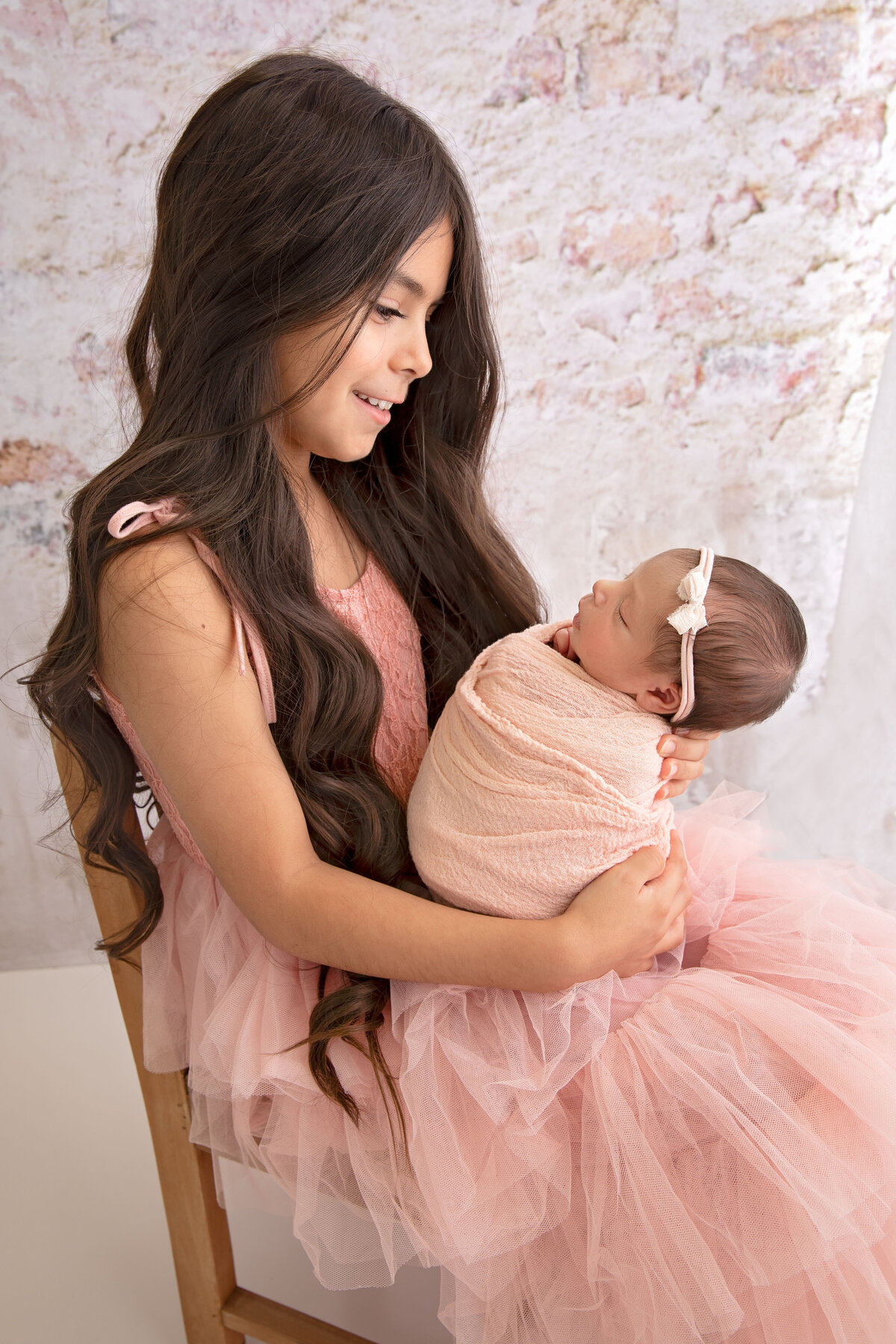 Custom-tailored newborn photography sessions in our studio ensure every image is as unique as your baby.
