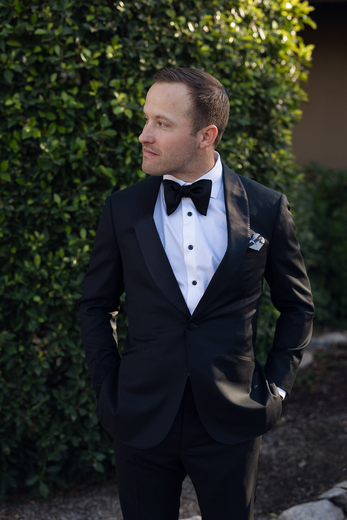 Groom posing for portrait on wedding day at Paradise Valley Country Club