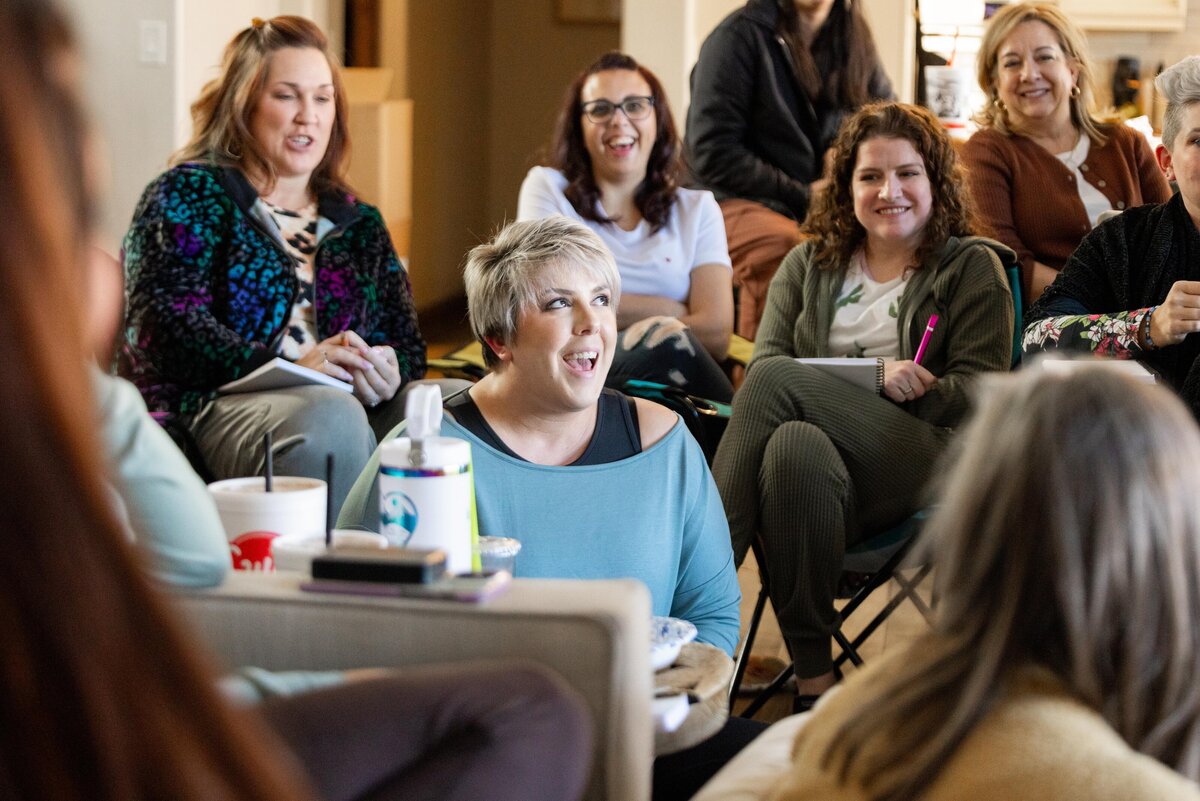 woman speaking up during a discussion within a group
