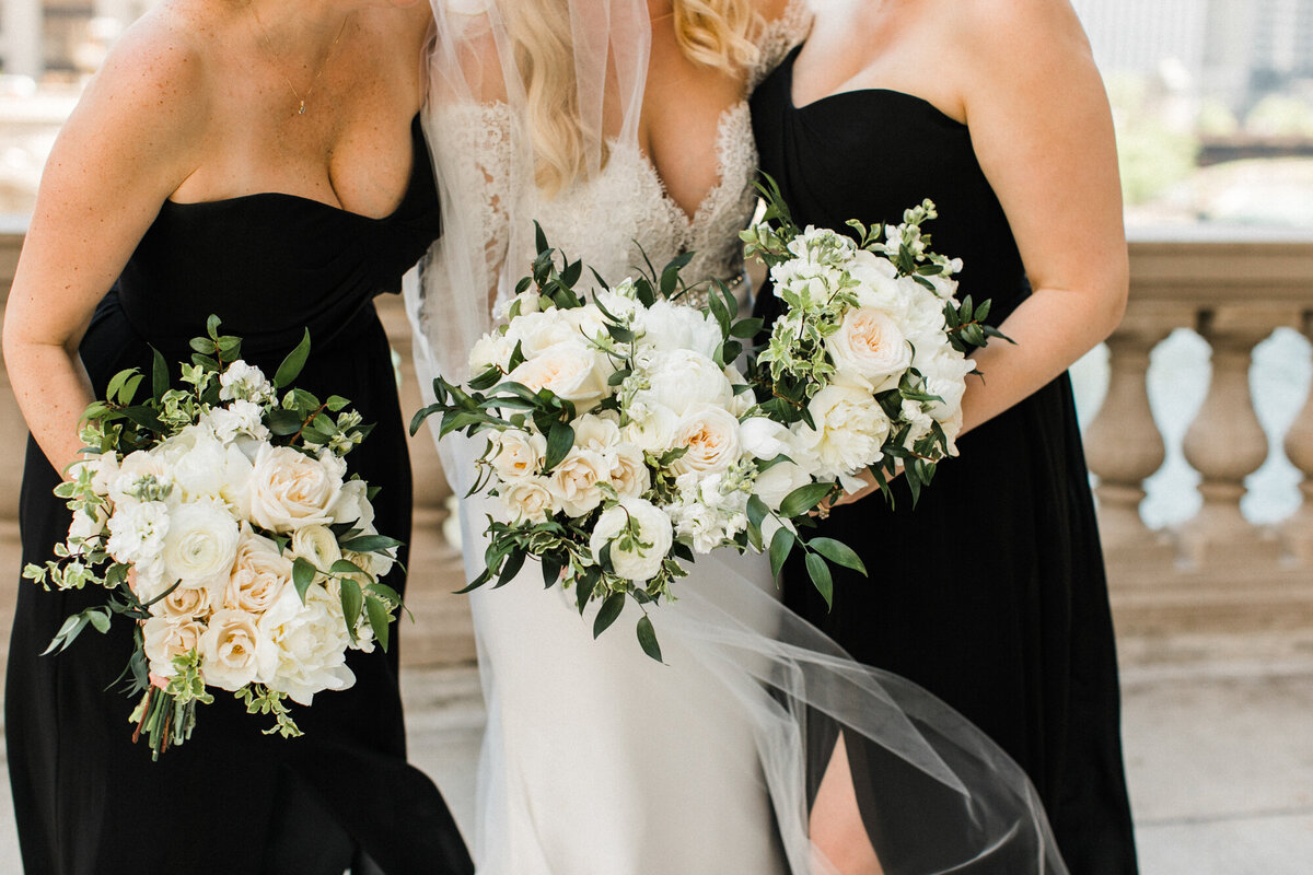 A beautiful wedding bouquet detail shot featuring the bride’s and bridesmaids’ white floral arrangements.