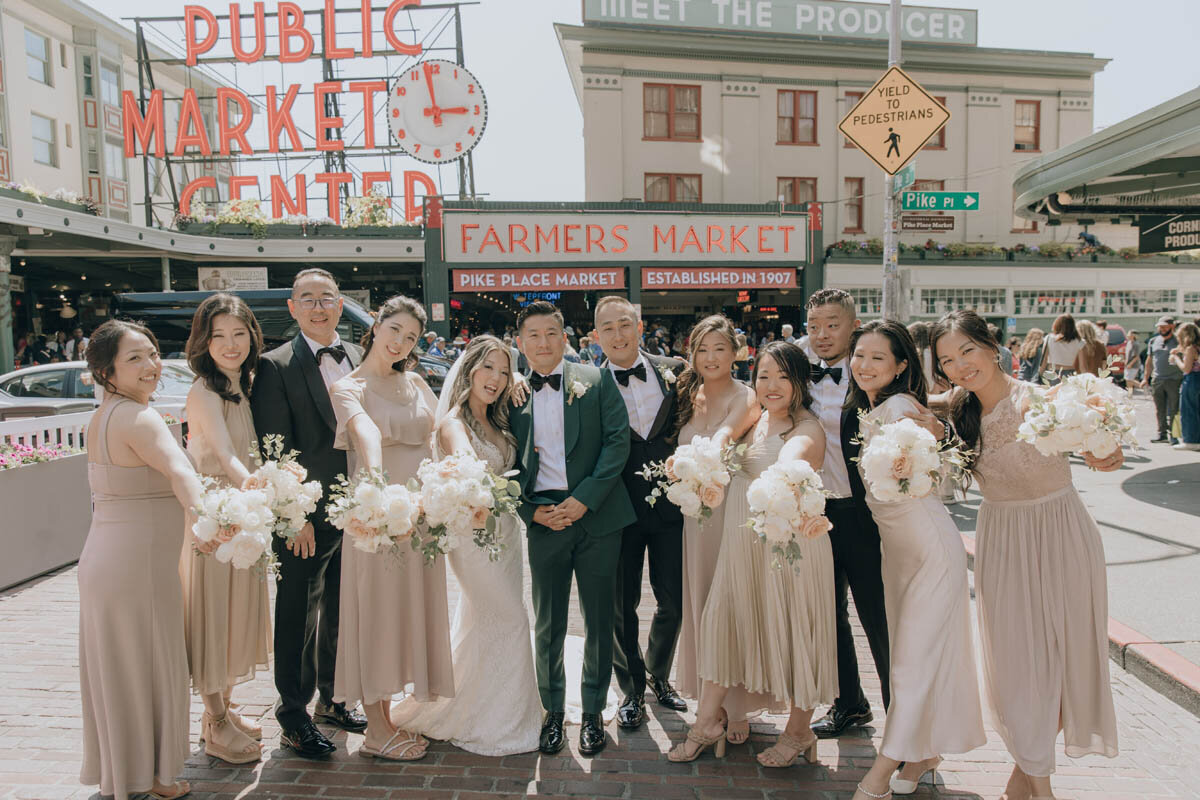 wedding party posed together at pike place market