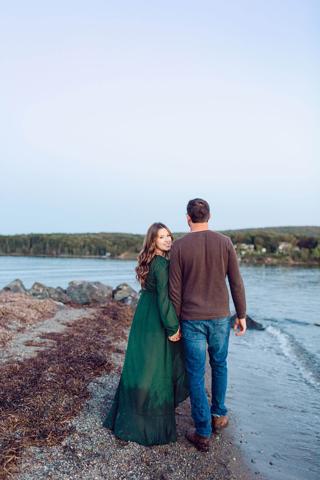 pregnant-woman-in-green-dress-walking-with-husband