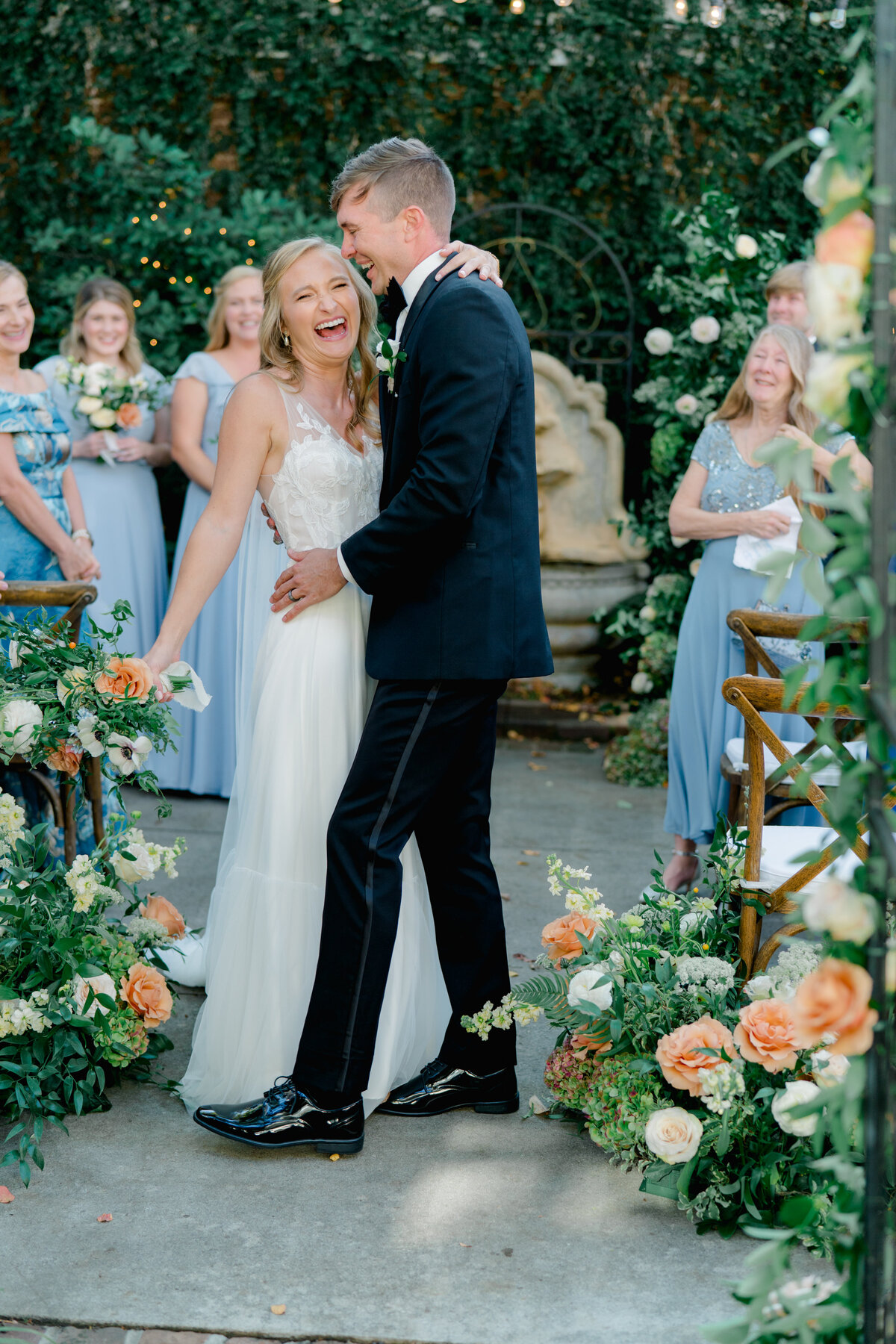 Fun bride and groom wedding ceremony dip kiss.