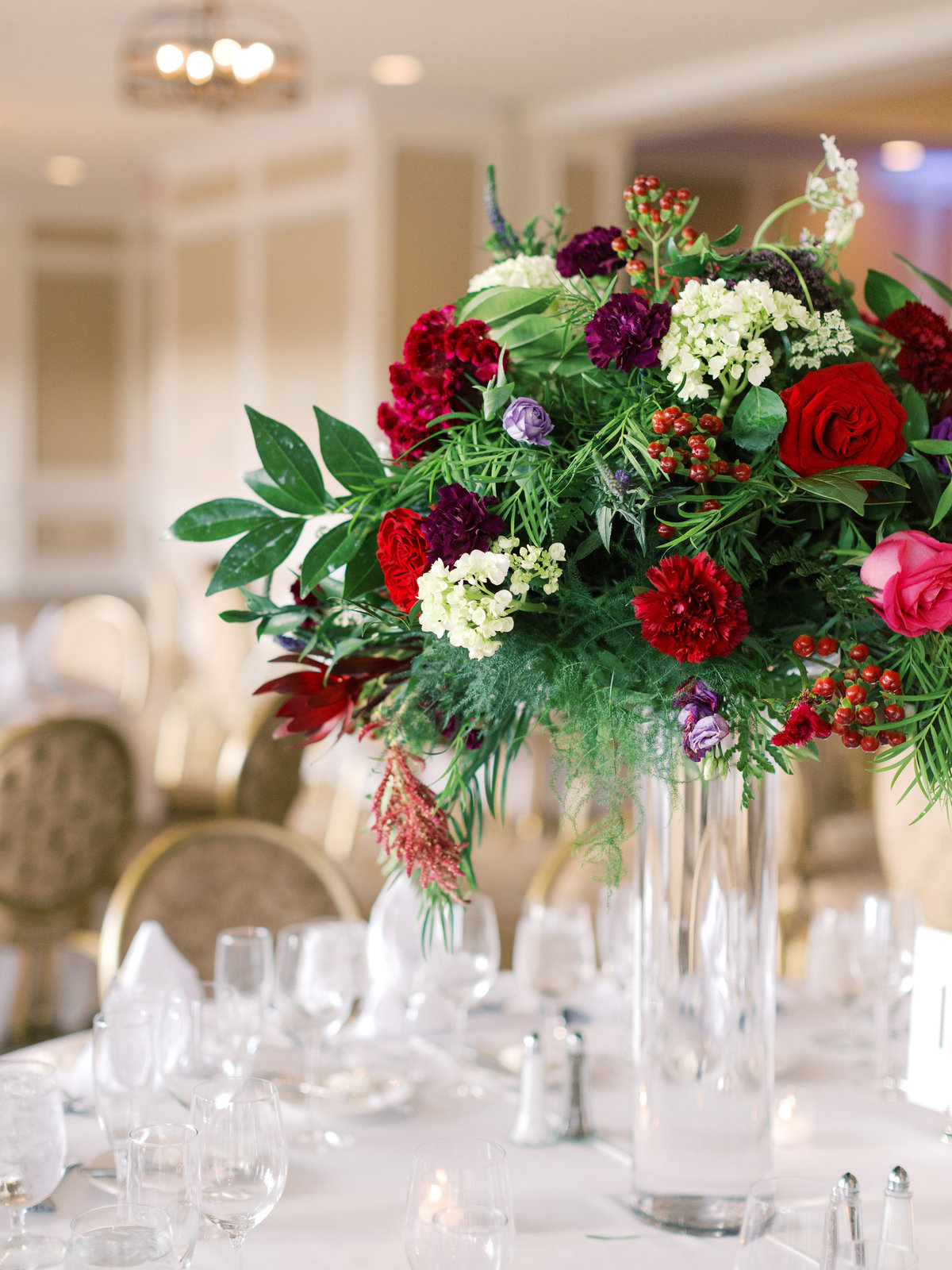 Elevated table arrangement with vivid floral colors