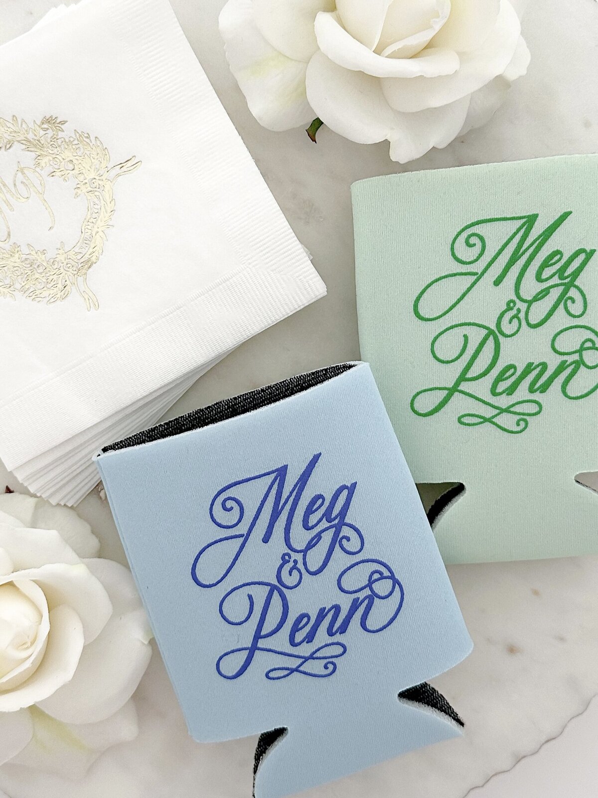 Custom can holders and beverage napkins with gold embossed wedding crest.