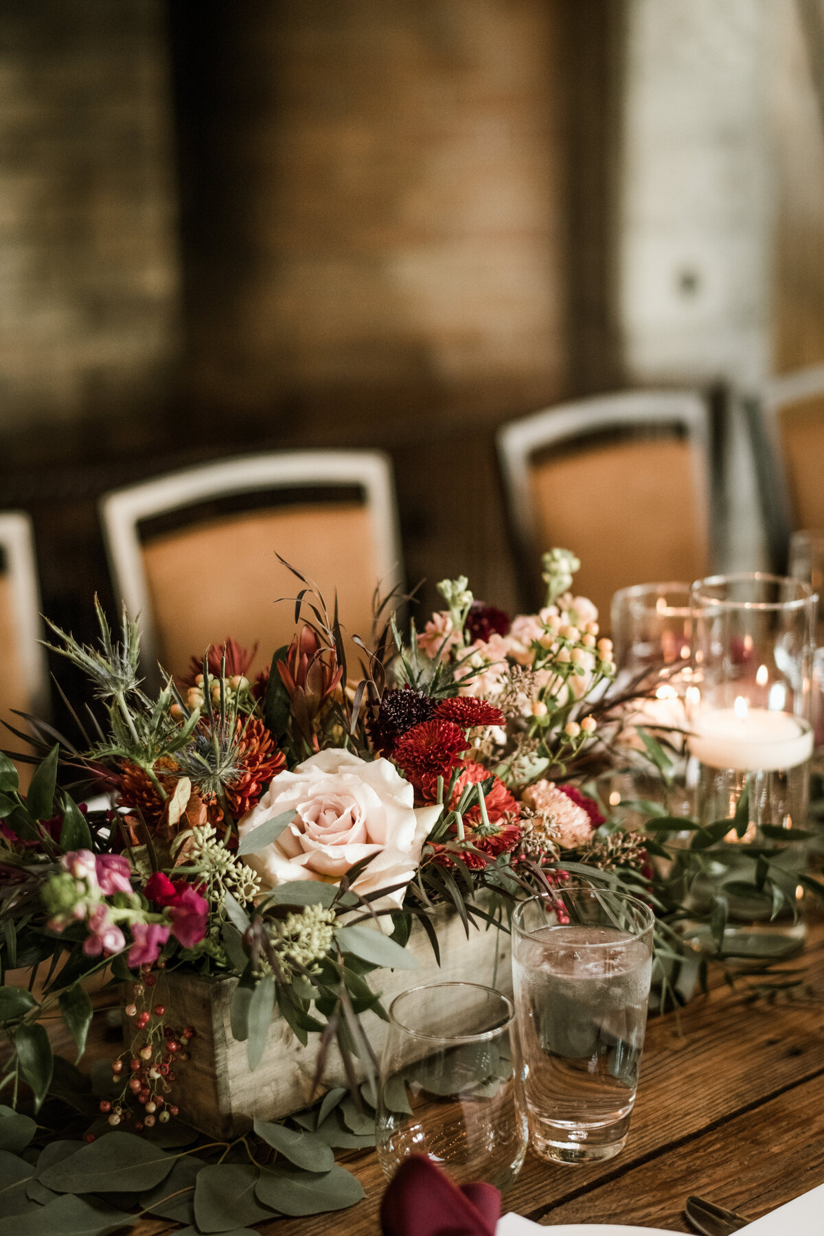 Burgundy and blush wedding centerpieces in aged wooden box at Brasada Ranch