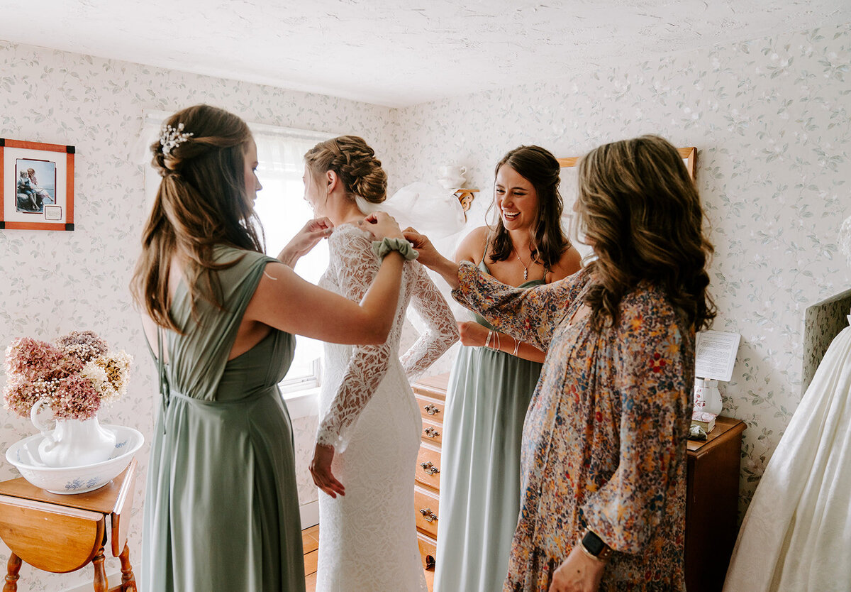 bride-getting-into wedding-dress