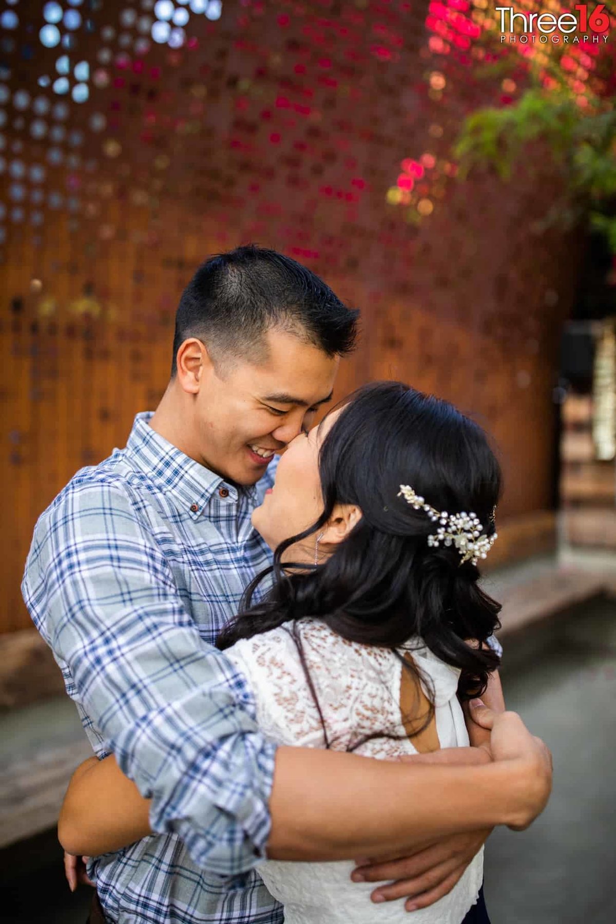 Big embrace between engaged couple during photo shoot