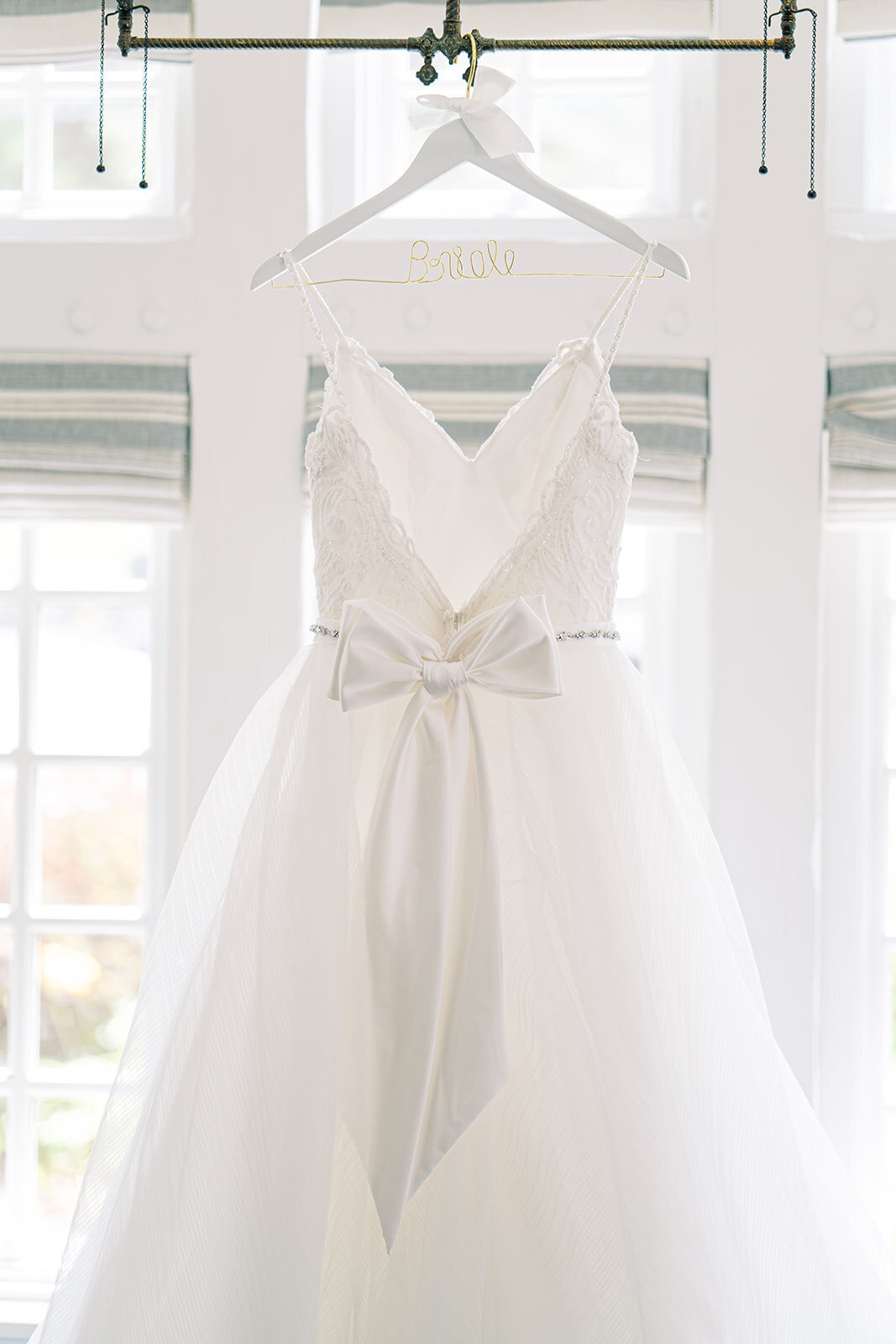close up of a wedding dress with a ribbon