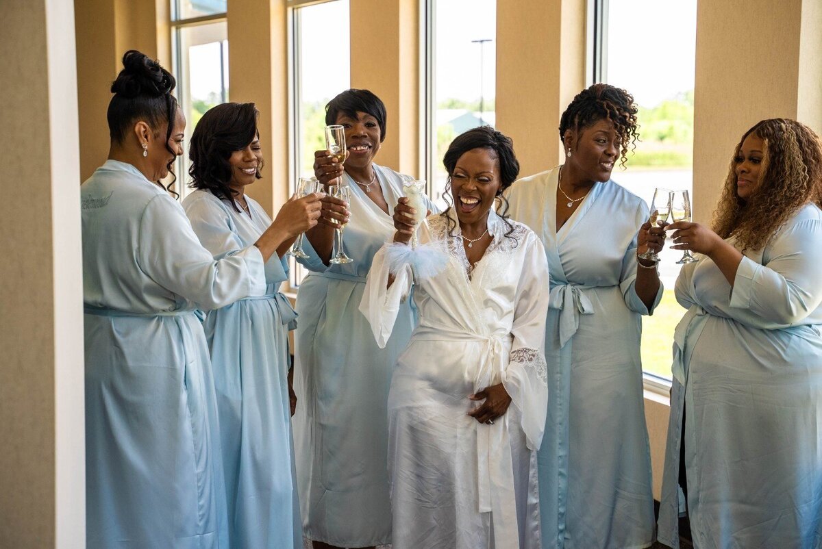 bride-bridesmaids-toast-mimosas-wedding-morning-duneland-falls