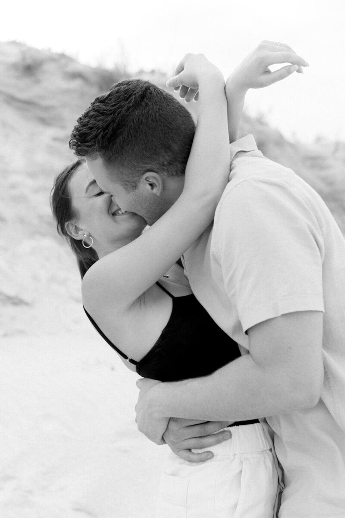 Couple kissing on beach taken by engagement photographers in orlando fl