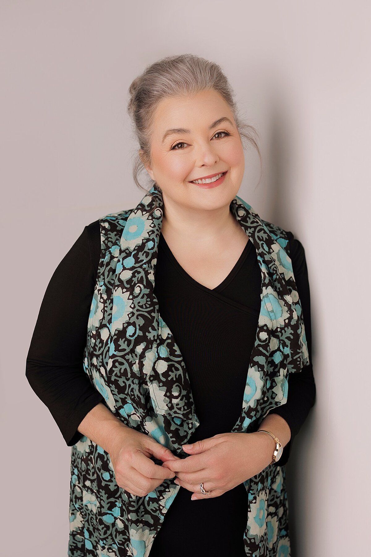 Corporate headshot with neutral backdrop and natural makeup, styled in-studio