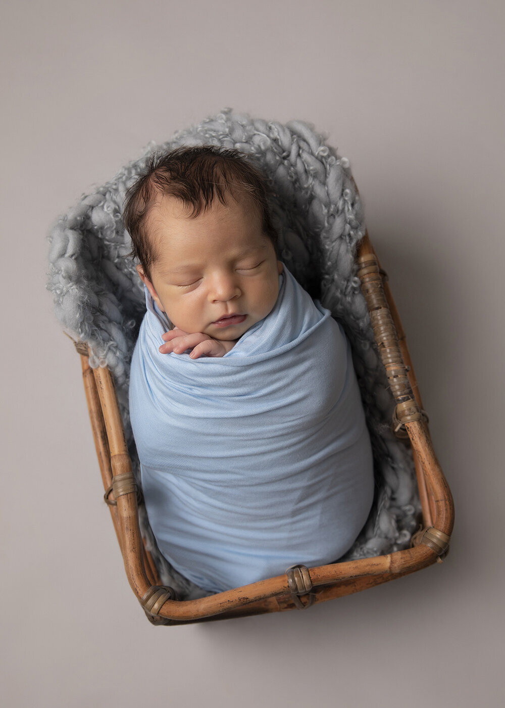 NEWBORN_BABYBOYWRPPAEDINABASKETINBLUE