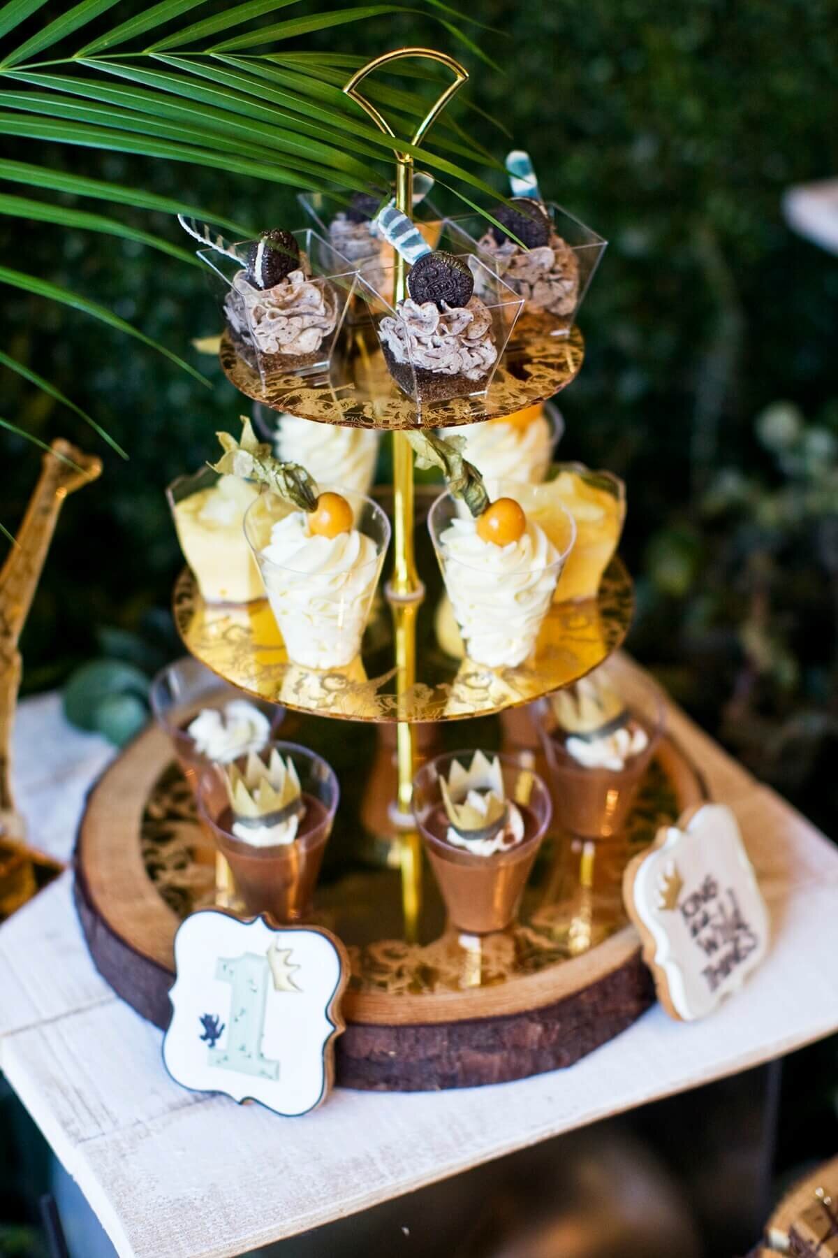 Jungle theme cup cake tower on a tree log plate