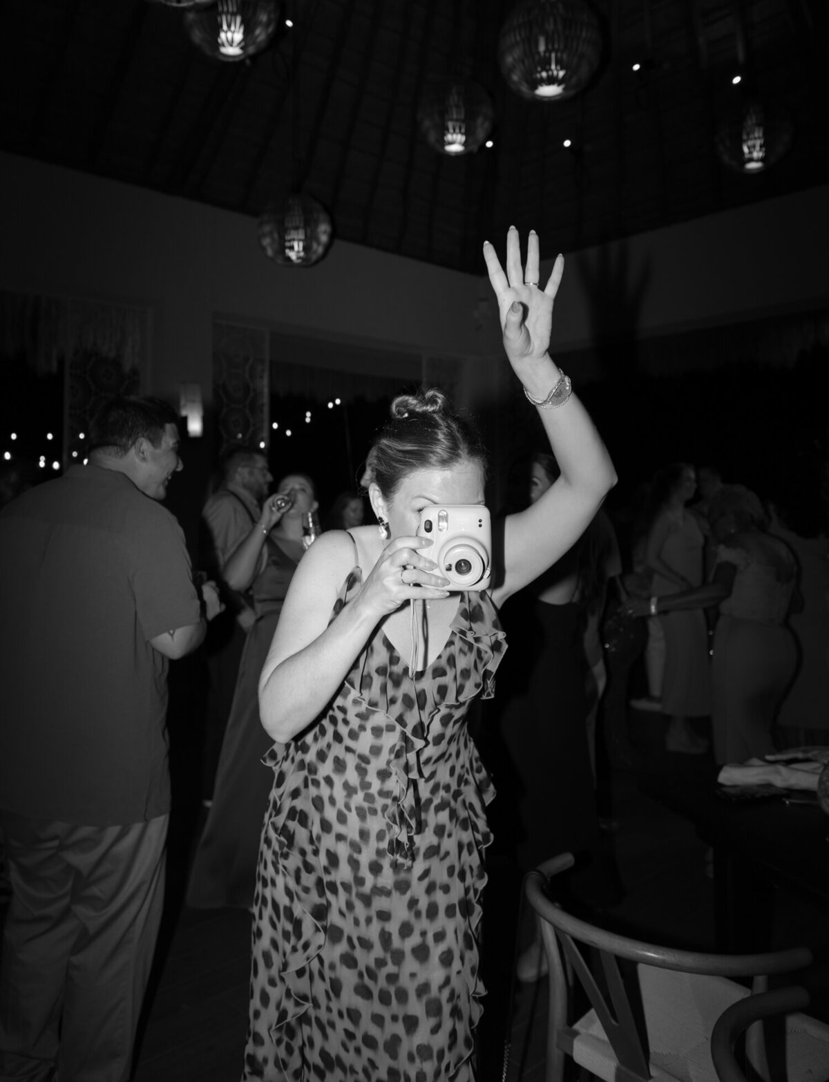 wedding guest takes photo with camera, dancing, Mexico wedding reception