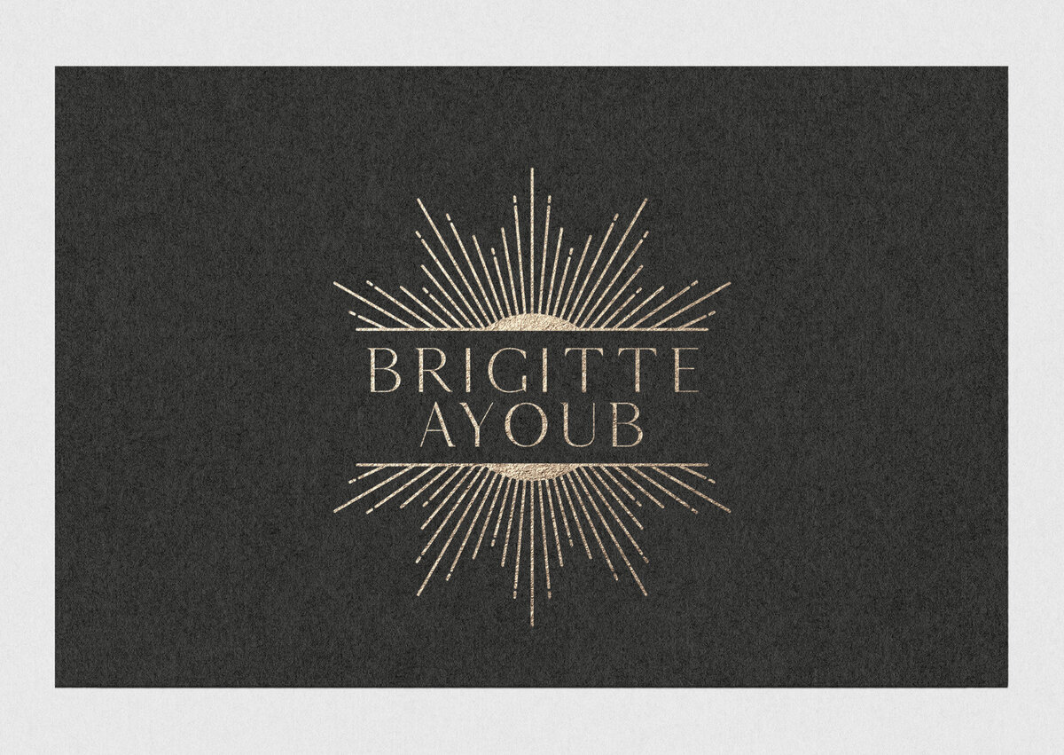 Black business card with gold foil logo "Brigitte Ayoub"