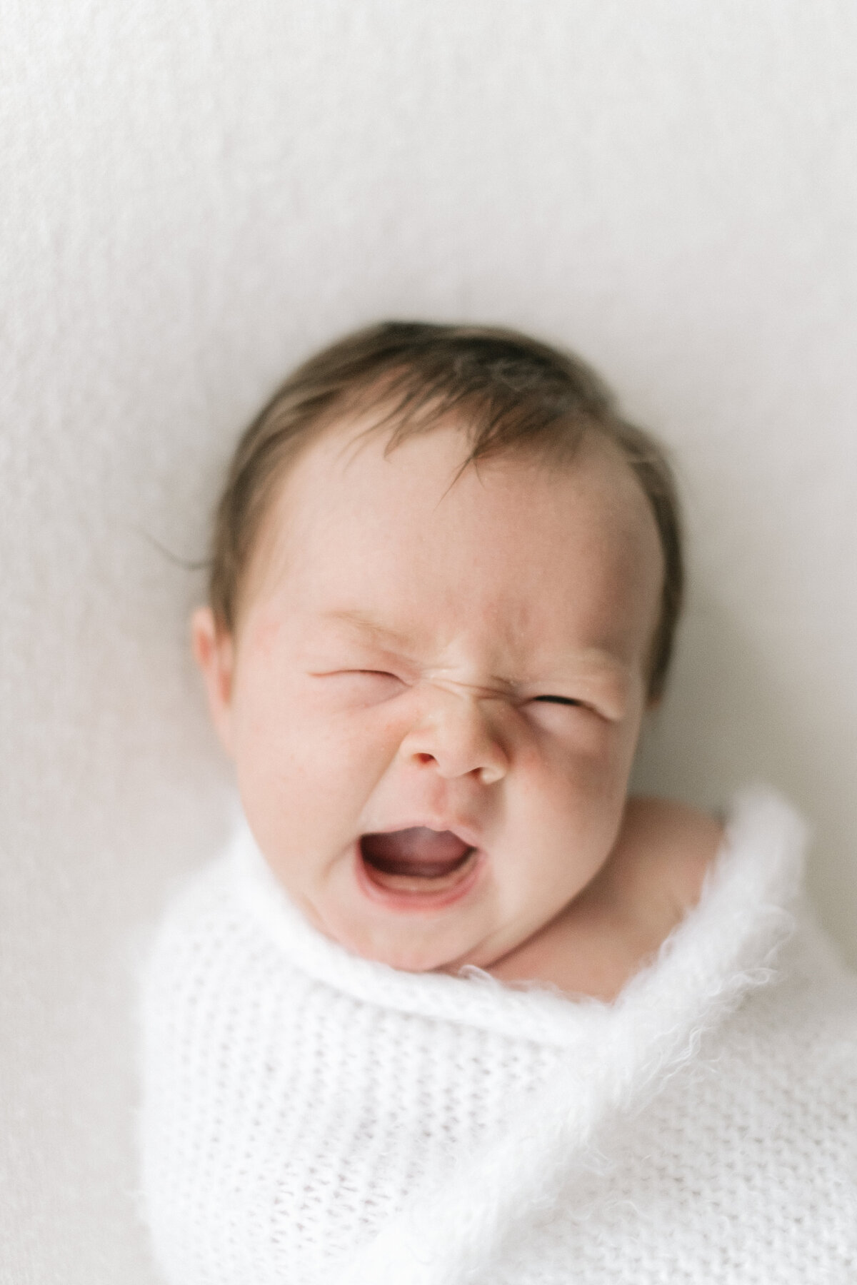 Adorable baby yawns during her newborn shoot