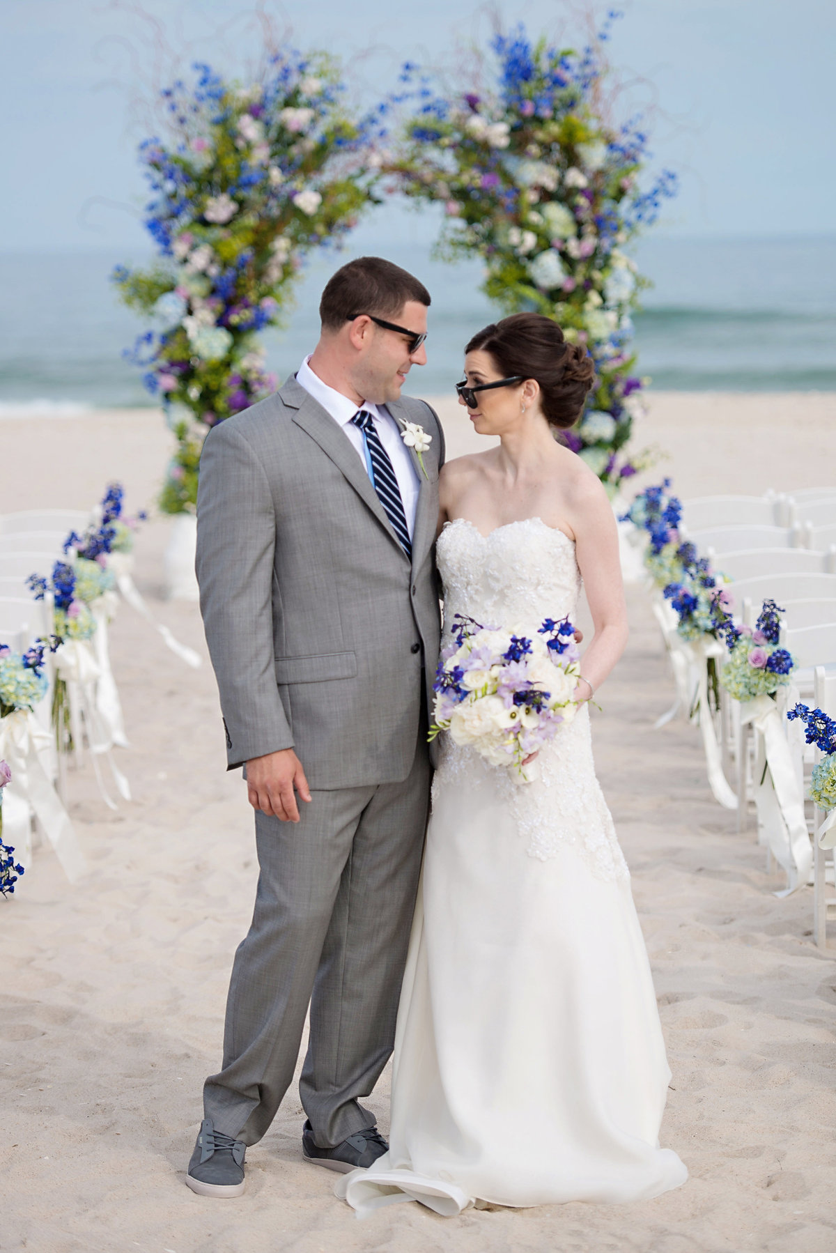 Bride and groom wearing sunglasses infront of their ceremony at Oceanbleu