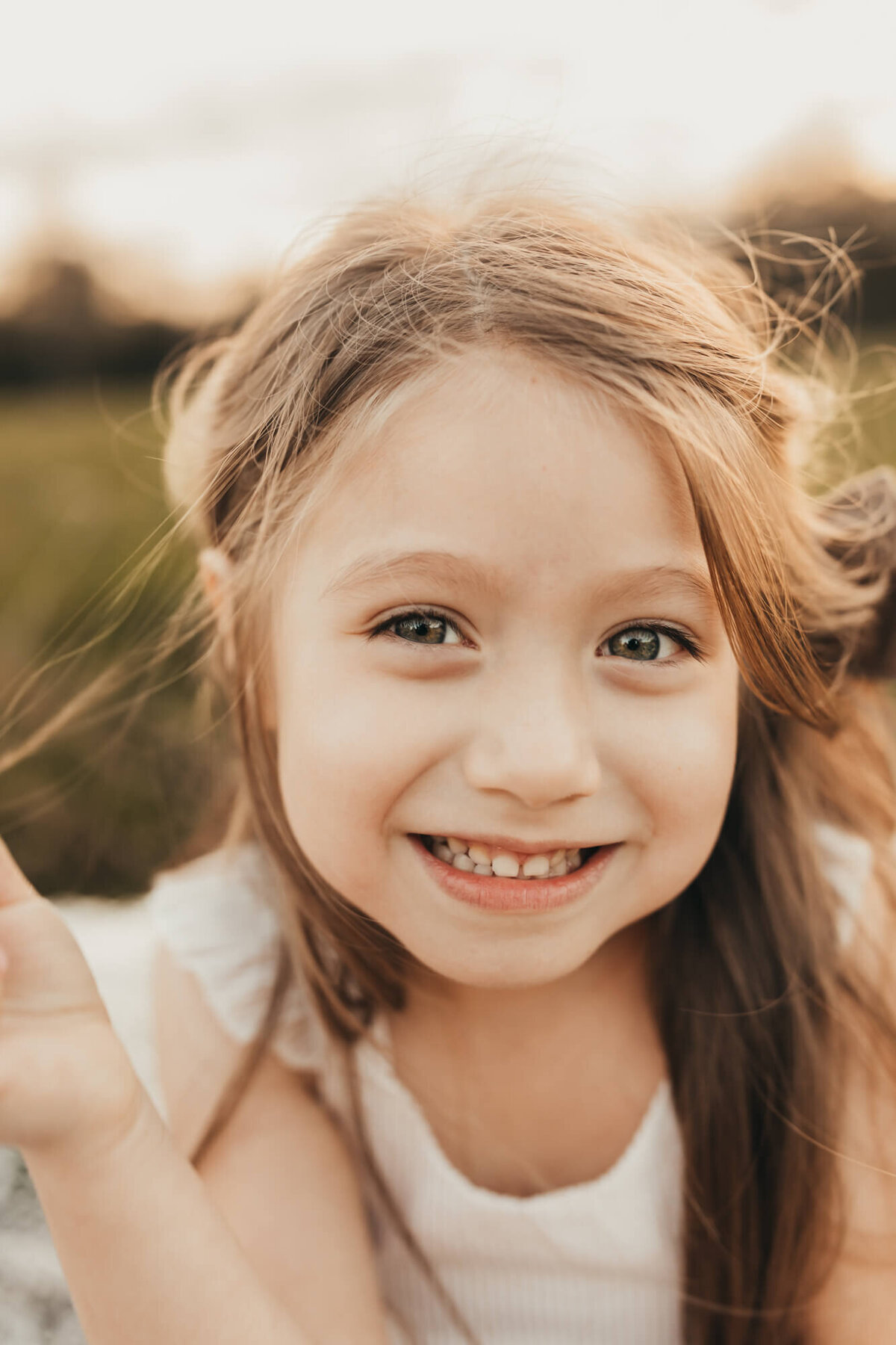 up close of little girl who is twirling her hair.