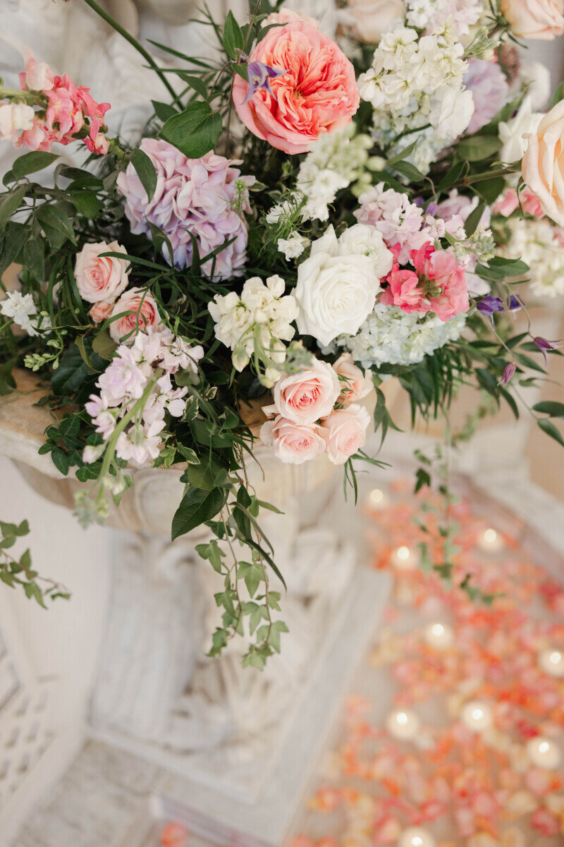 pink and peach flower arrangement with cascading greenery
