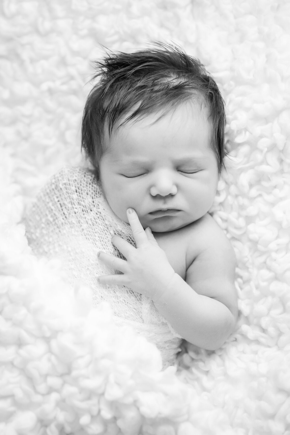 Newborn baby girl portrait in black and white natural