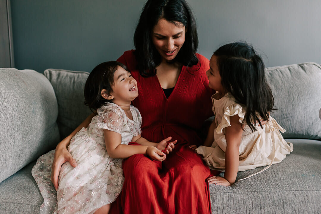 A mom and her girls enjoying a laugh together