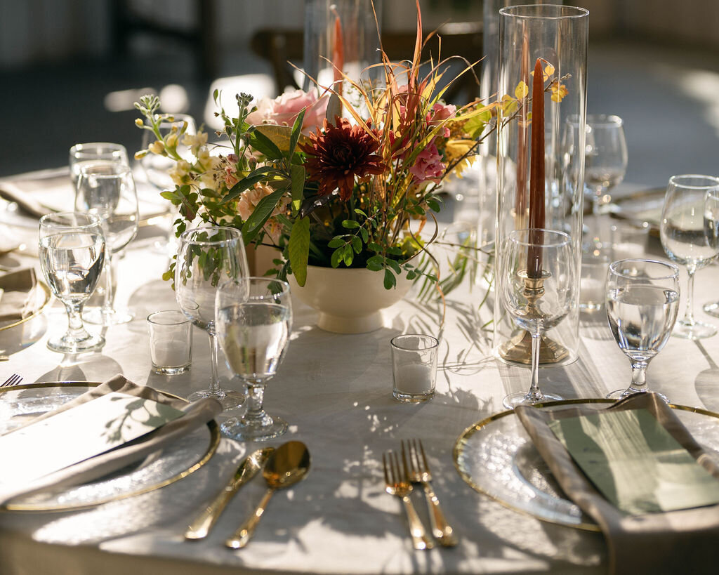 Rust-sage-wedding-reception-table-candles-floral-arrangement