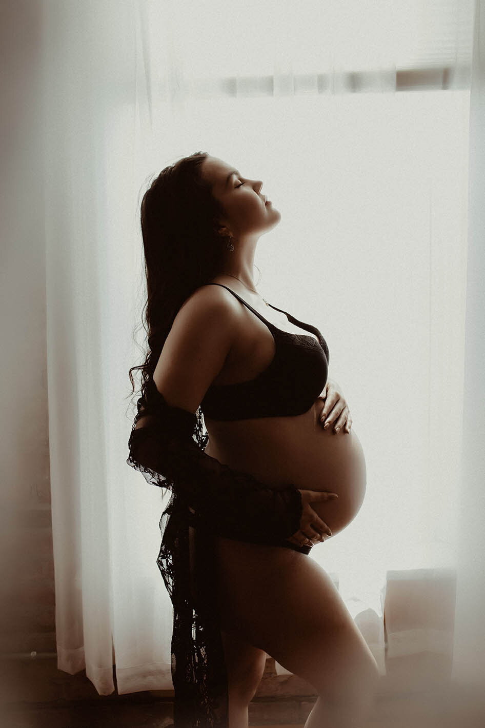 A silhouette shot of a pregnant woman