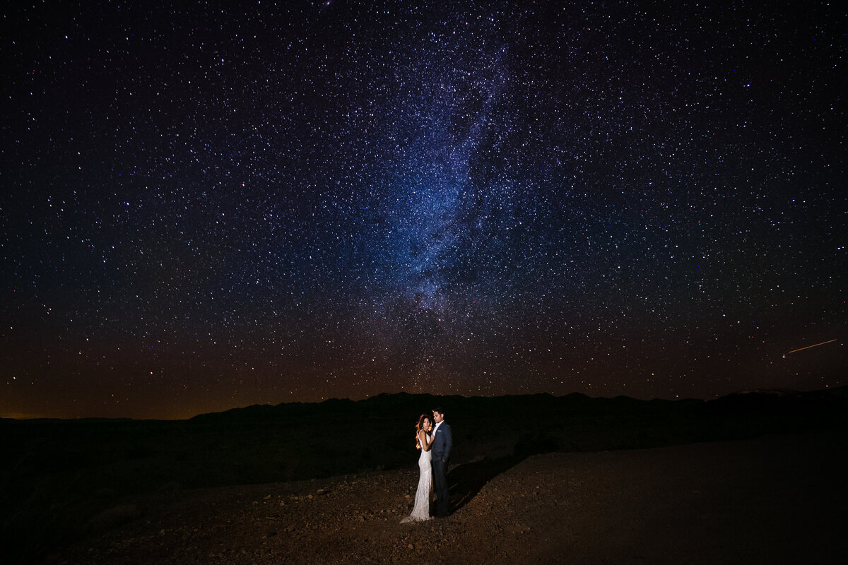 Newlyweds pose for a midnight session under the milky way in Death Valley National Park California, photo by Tanya Parada
