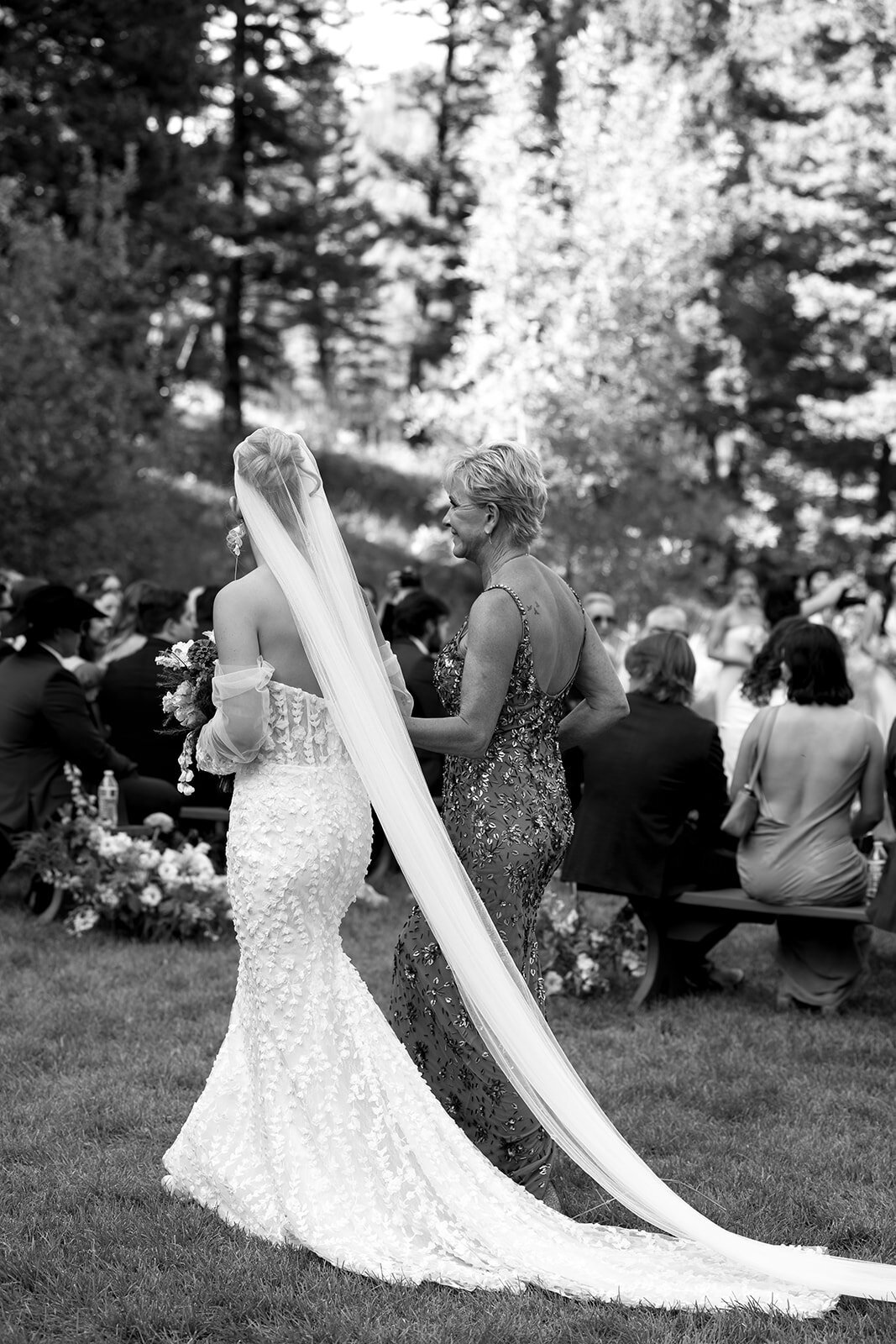 Big Sky wedding photographer portfolio: adventurous couple walking away from the camera in a vast outdoor setting, captured in cinematic black and white.