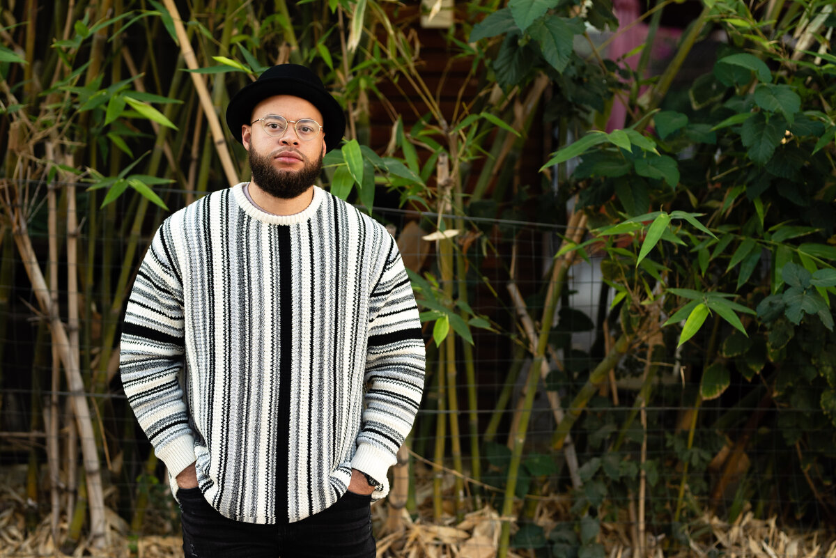 Photo of guy with black and white sweater and a hat