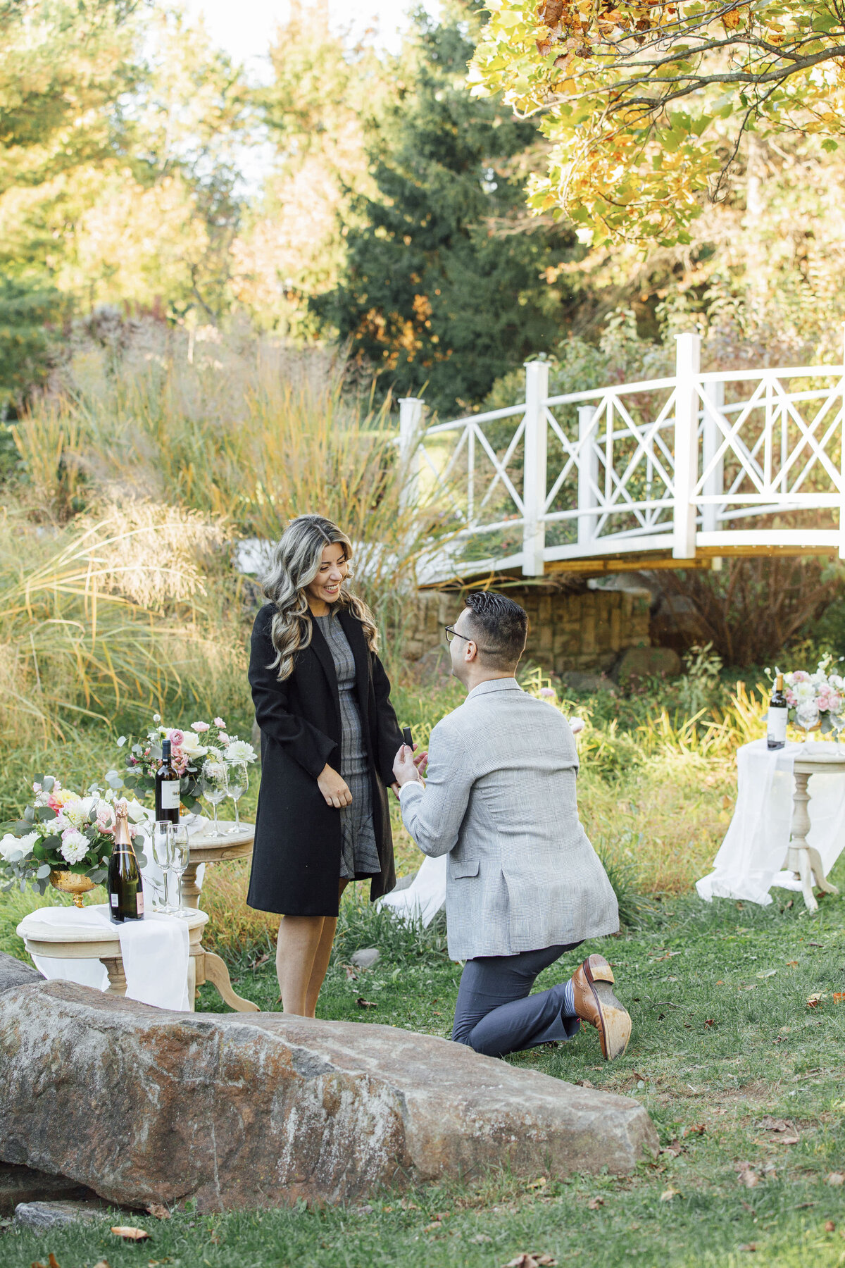 Proposal Photographer | Groom-to-be proposing in the gardens surrounded by vibrant flowers at Sayen House and Gardens | Hamilton Township, New Jersey