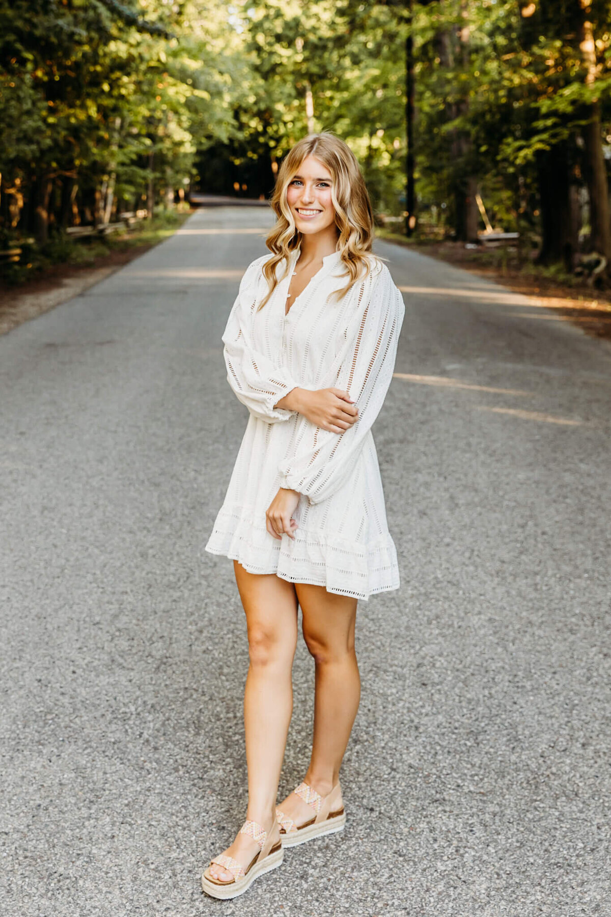 girl in white dress smiling on a backroad in Door County