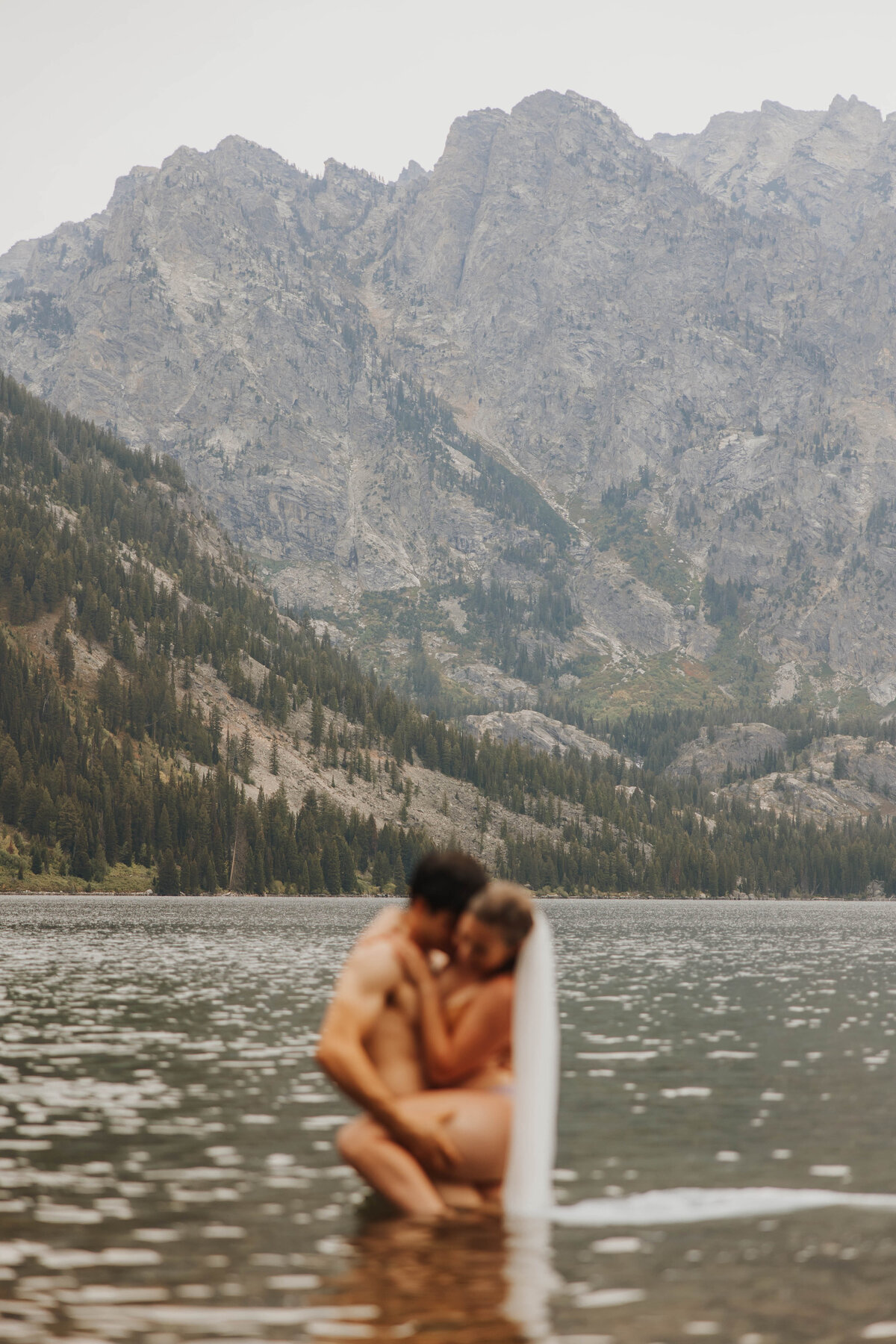 bride and groom posing in lake