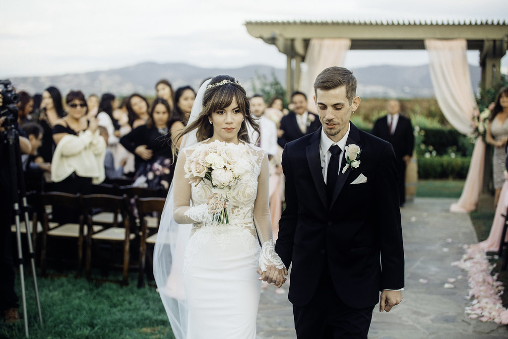 Wedding Photograph Of Bride And Groom Holding Hands While Walking Los Angeles