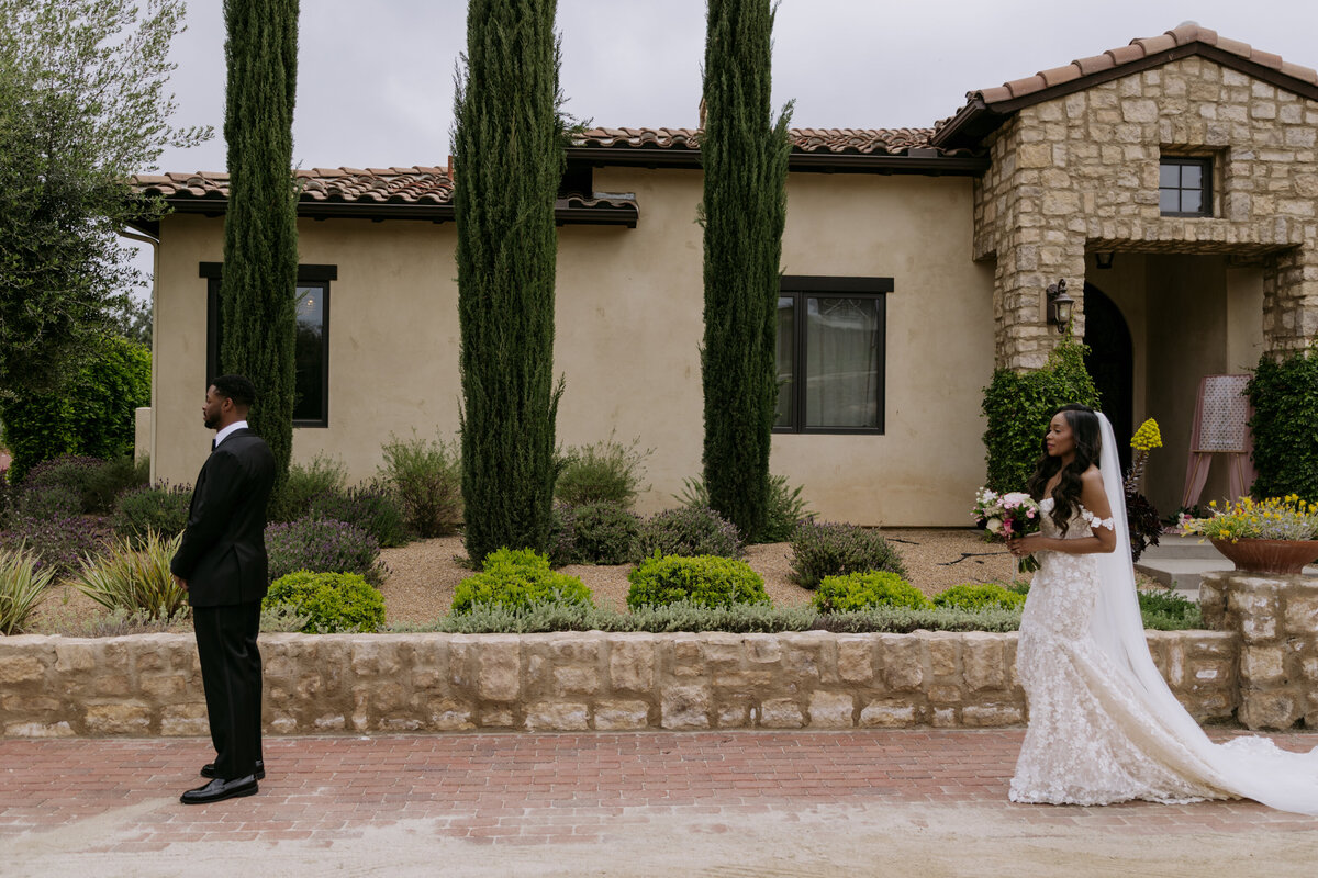 Keiyana walking up to Chase for their first look, at their wedding in Temecula.