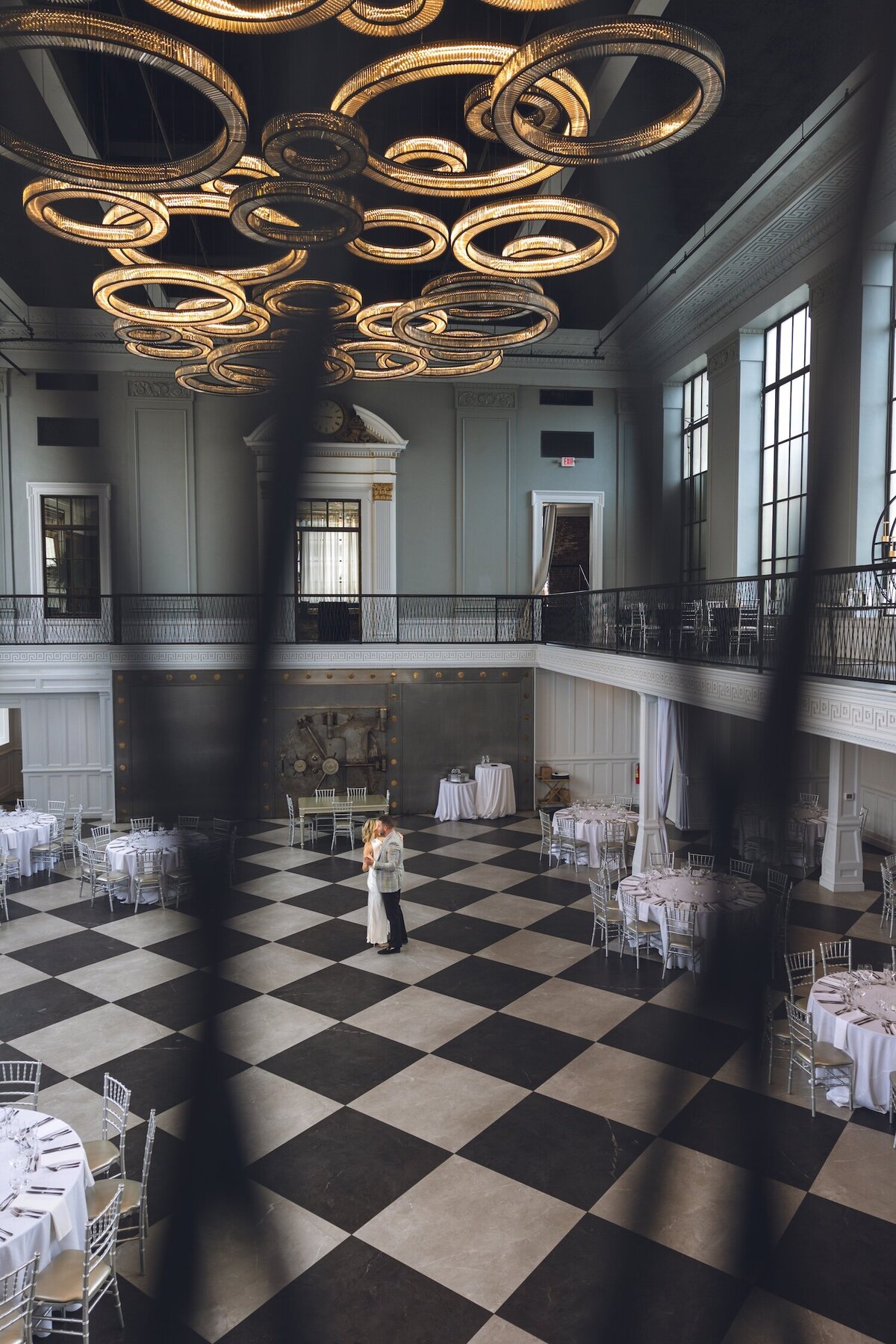 Wide shot of Felina’s modern black-and-white checkered ballroom with couple embracing down below.