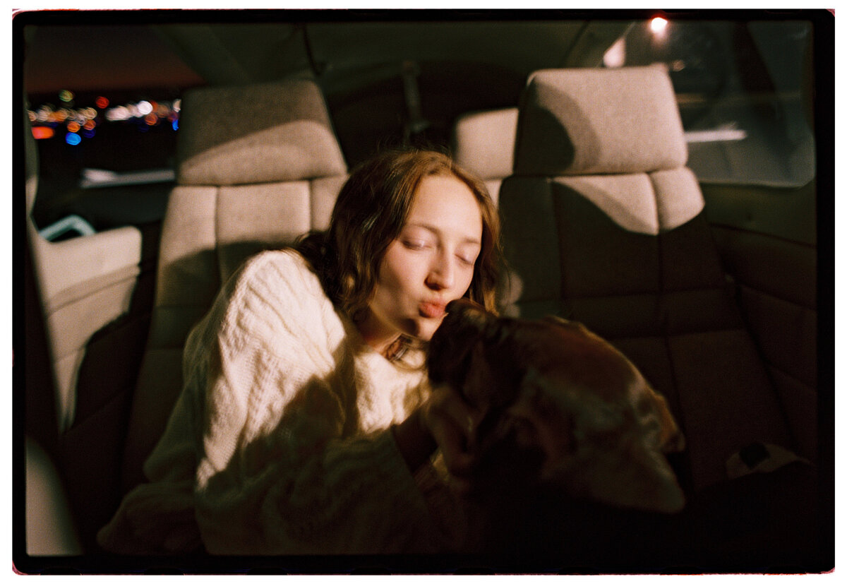 Woman kissing her dog, captured on film in an authentic, candid moment by Kate Winters Photography, Carmel, CA