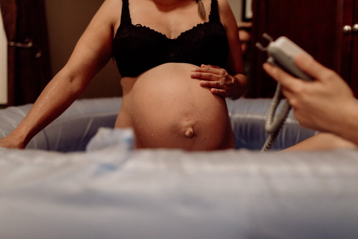 spokane-home-birth-client+in+pool+with+doppler