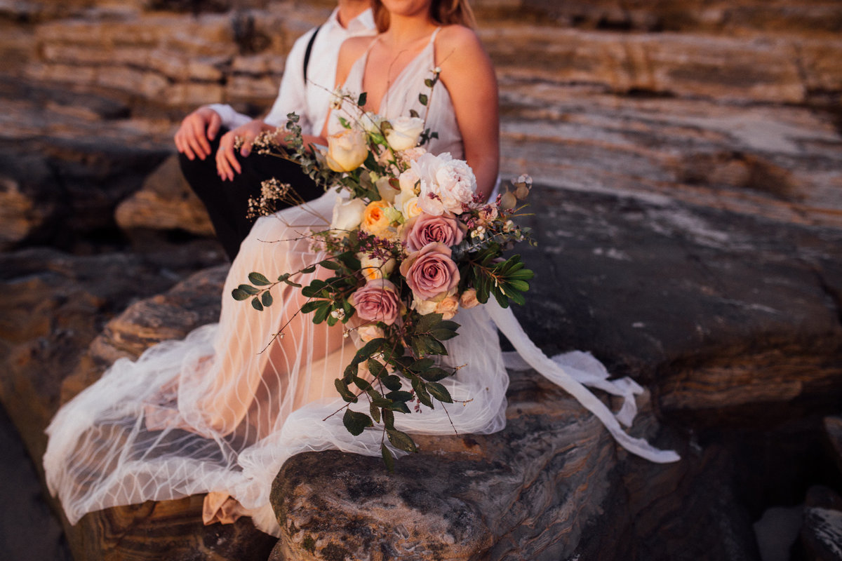 Bridal bouquet during sunset on the beach elopement in San Diego California