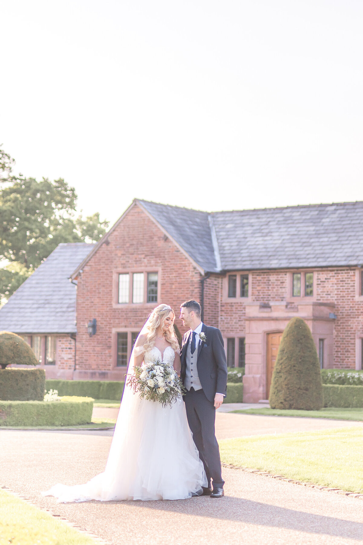 Bride and groom stood outside Merrydale Manor Cheshire